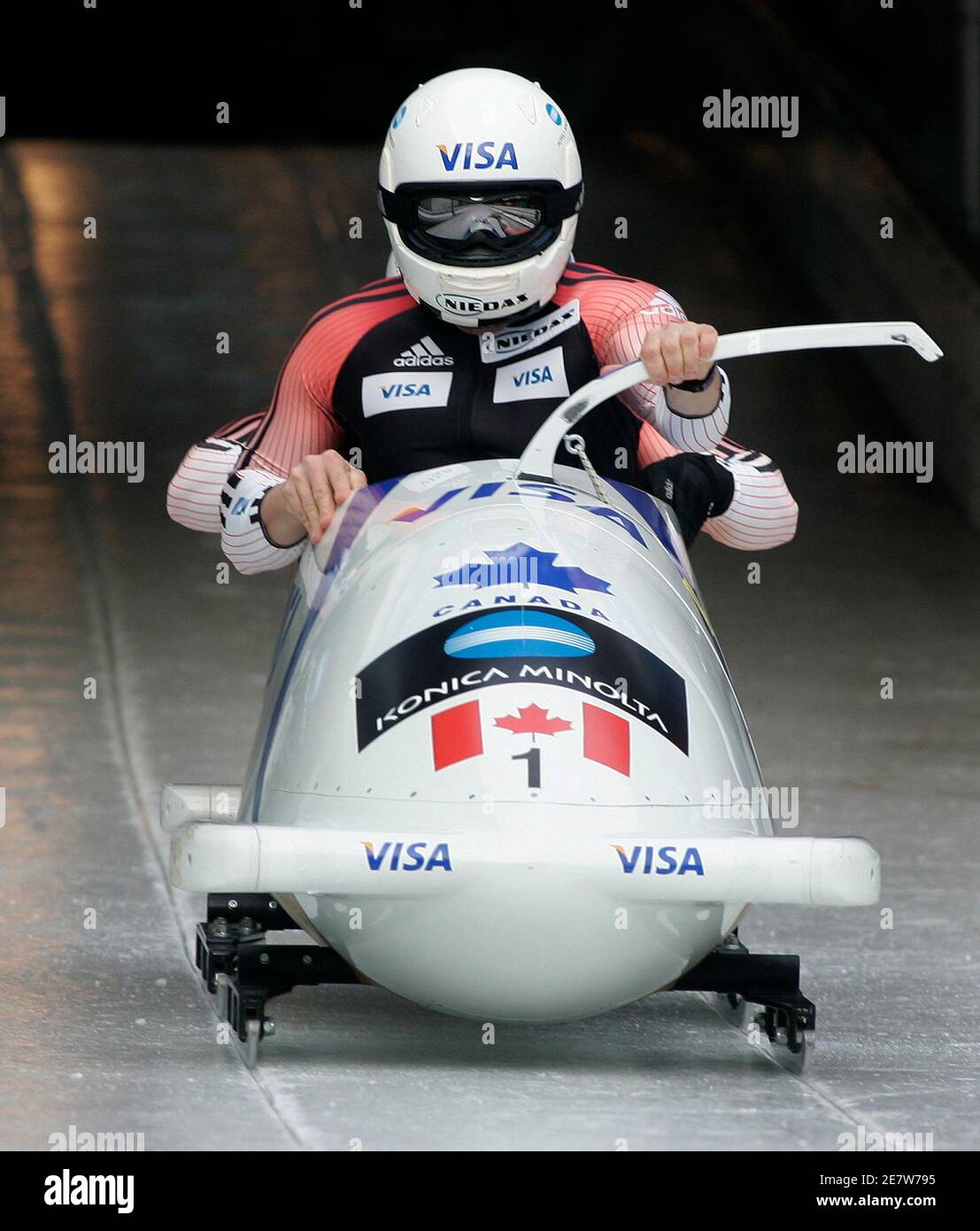 Team Canada 1 with Pierre Lueders (front) and David Bissett ride their bobsleigh during the first run of the bobsleigh World Cup final race in the southern Bavarian resort of Koenigssee, February 23, 2007. Team Germany 1 with Andre Lange and Kevin Kuske won the race ahead of Team Germany 2 with Matthias Hoepfner and Andreas Porth and Team Canada 1.   REUTERS/Alexandra Beier (GERMANY) Stock Photo