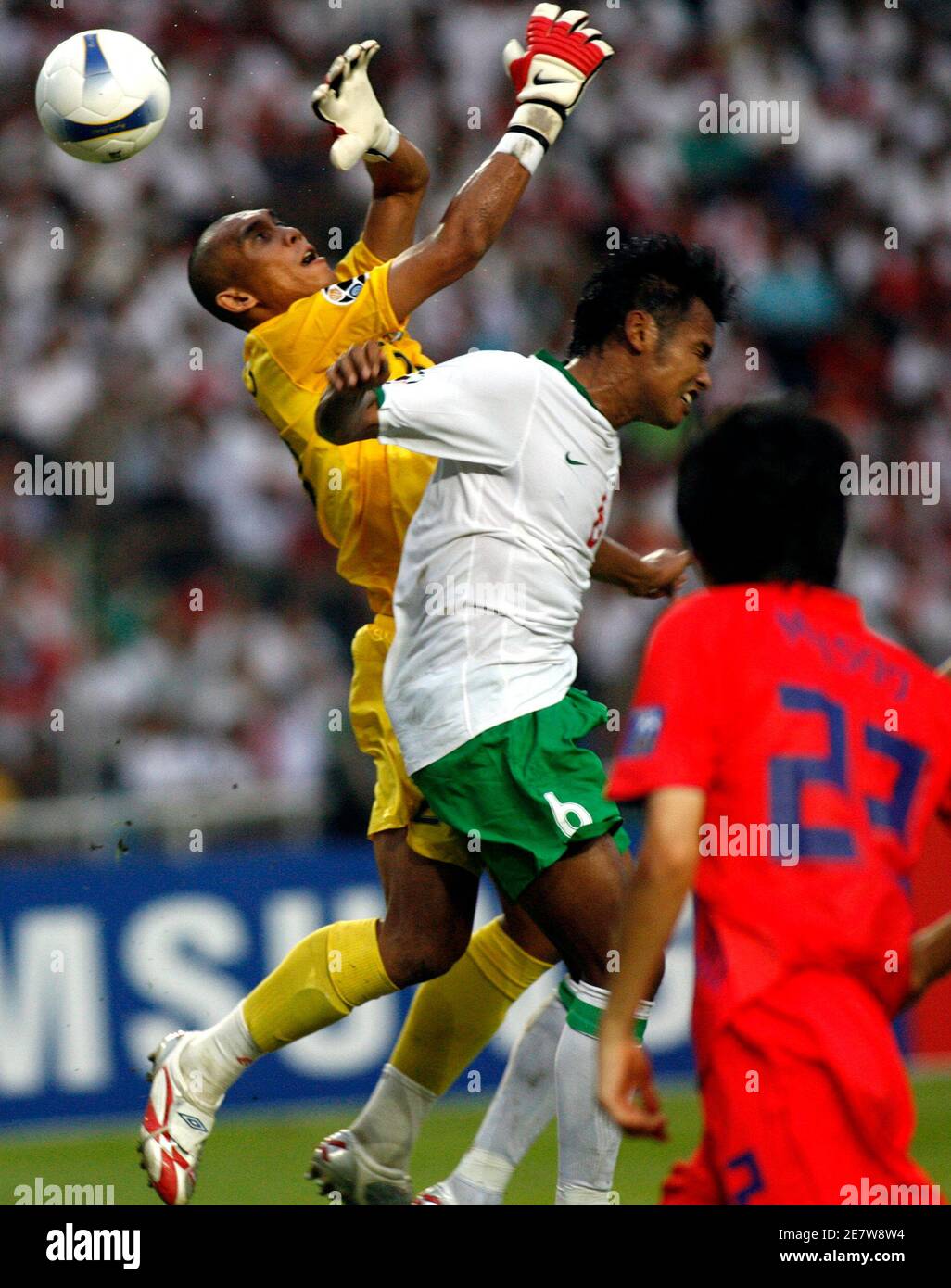 Indonesia's goalkeeper Markus Horison Ririhina (L) and team mate Charis Yulianto (C) go for the ball during their 2007 AFC Asian Cup Group D soccer match against South Korea in Jakarta July 18, 2007. REUTERS/Supri  (INDONESIA) Stock Photo