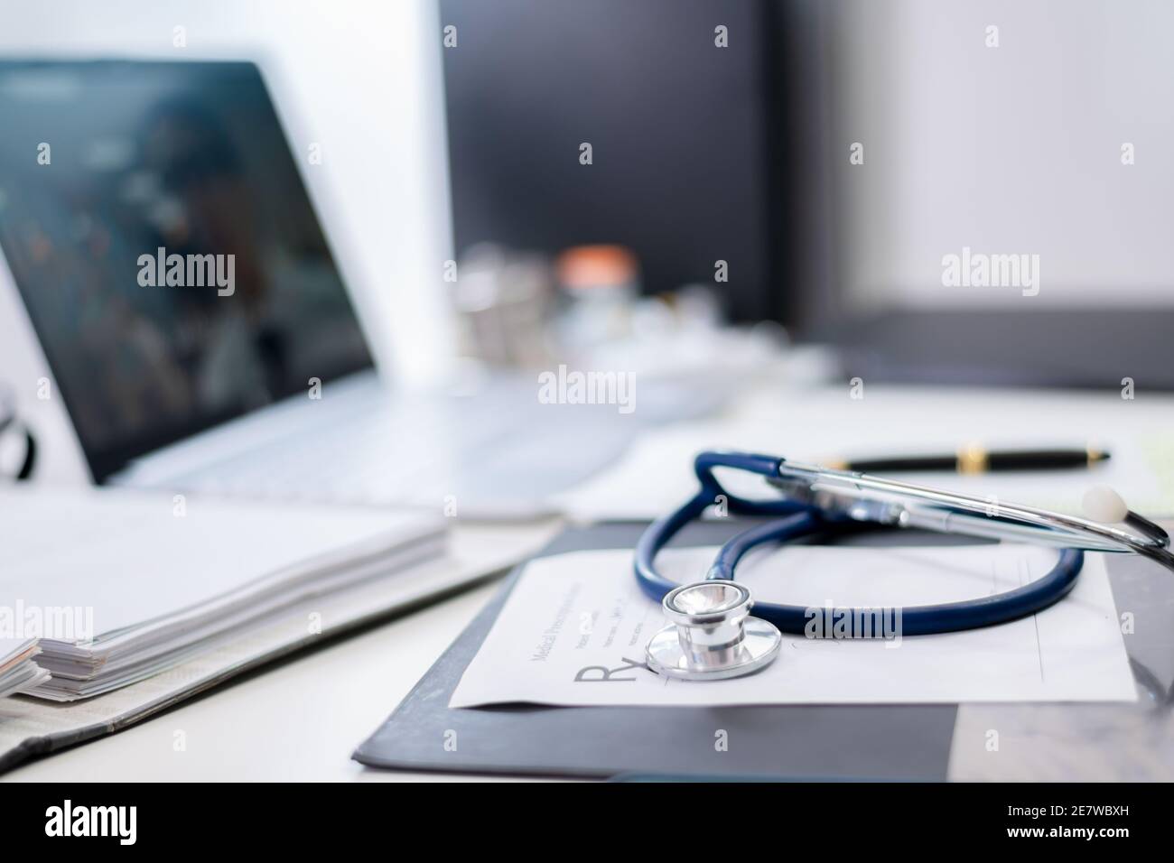 Close up Stethoscope on a table in a physician examination room. Doctor write a prescription or records patient examine results for the patient Stock Photo