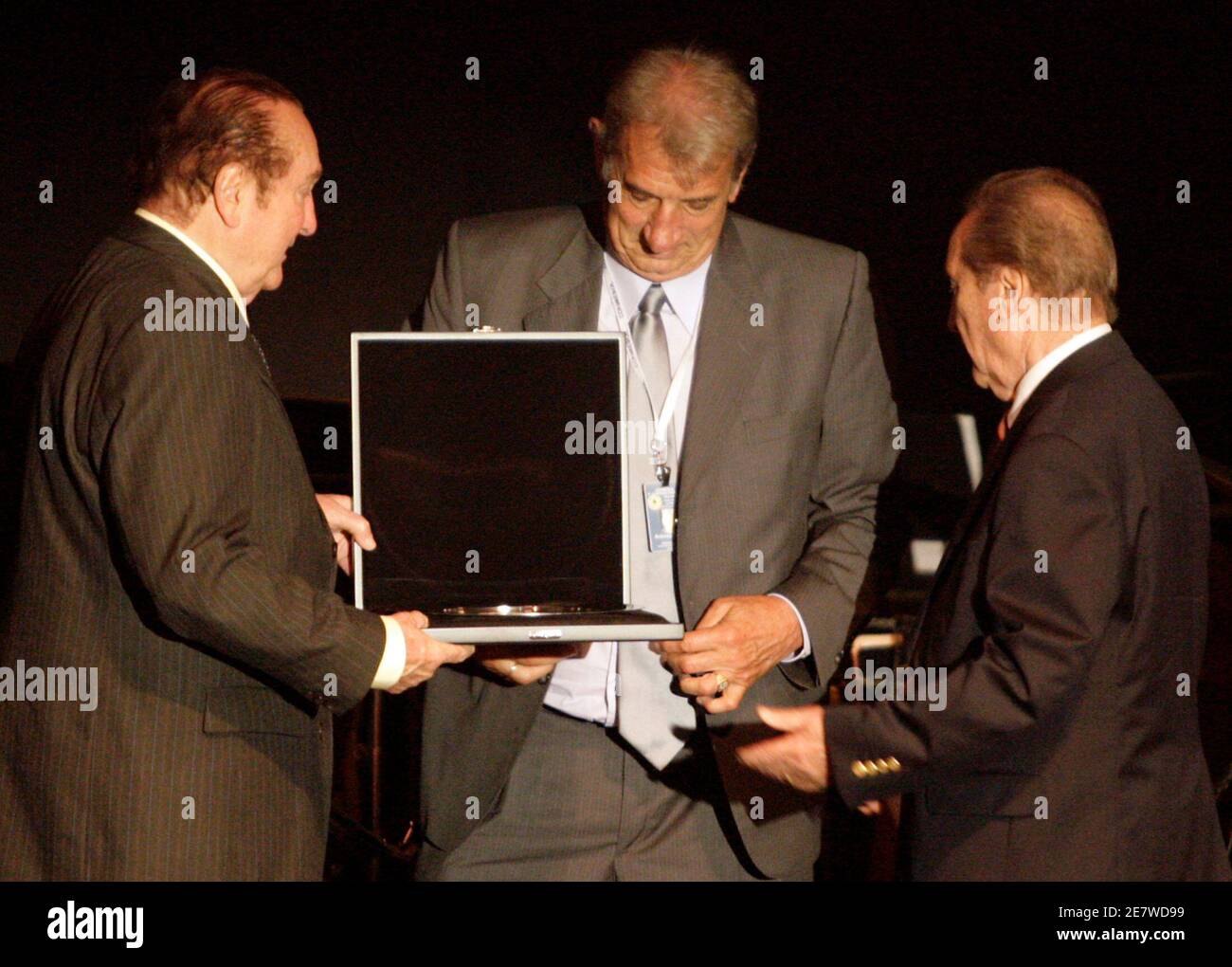 Former Argentine soccer player Antonio Rattin (C) receives a medal for his achievements during the inauguration of the first museum of South American soccer in Luque, near Asuncion January 29, 2009. REUTERS/Jorge Adorno (PARAGUAY) Stock Photo
