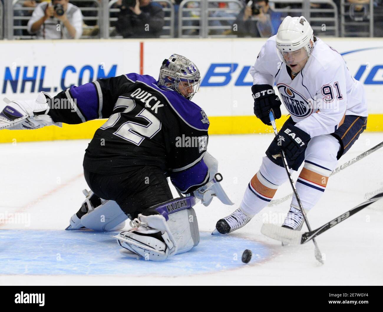 Edmonton Oilers center Mike Comrie (R) gets the puck past Los Angeles Kings goaltender Jonathan Quick to score during the first period of their NHL hockey game in Los Angeles, California, April 10, 2010. The Oilers won the game. REUTERS/Gus Ruelas (UNITED STATES - Tags: SPORT ICE HOCKEY) Stock Photo