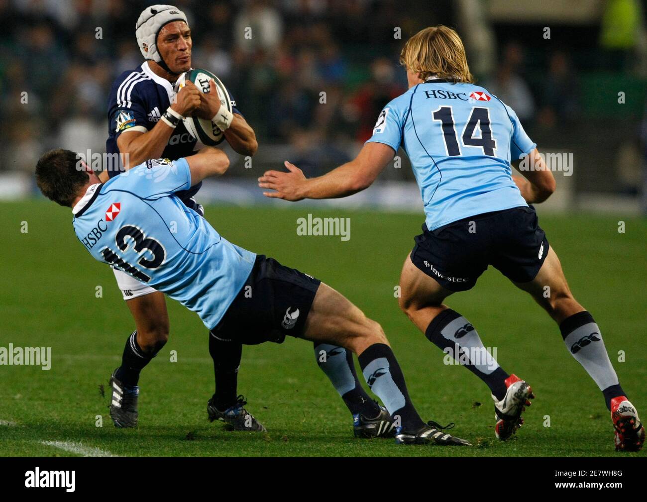 Gio Aplon of South Africa's Stormers attempts to break past Rob Horne (L) and Lachie Turner (R) of Australia's NSW Waratahs during their Super 14 semi-final rugby union match in Cape Town, May 22, 2010.  REUTERS/Mike Hutchings (SOUTH AFRICA - Tags: SPORT RUGBY) Stock Photo