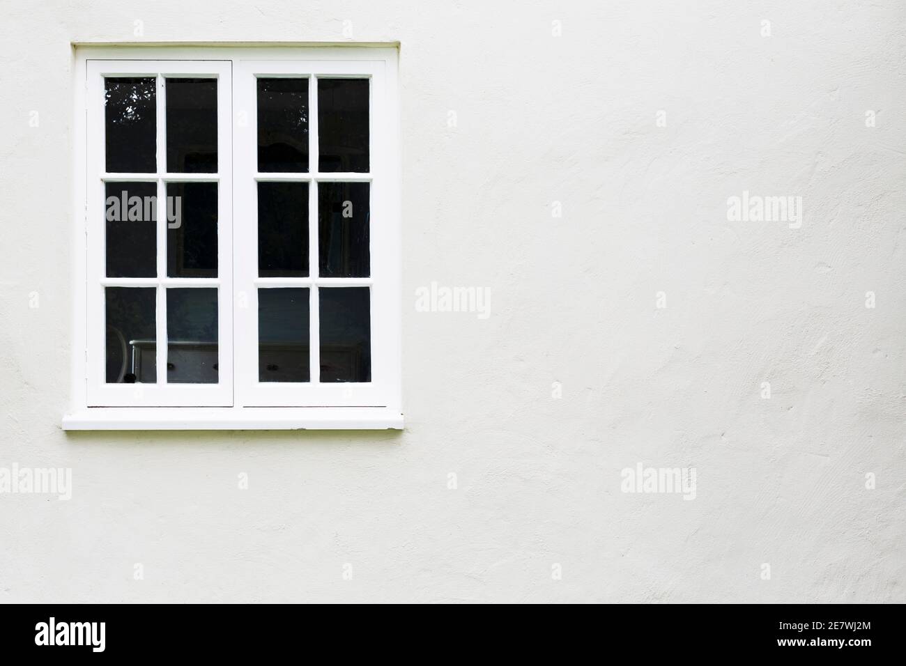 Window background. White timber or wooden windows on a house in UK. Stock Photo