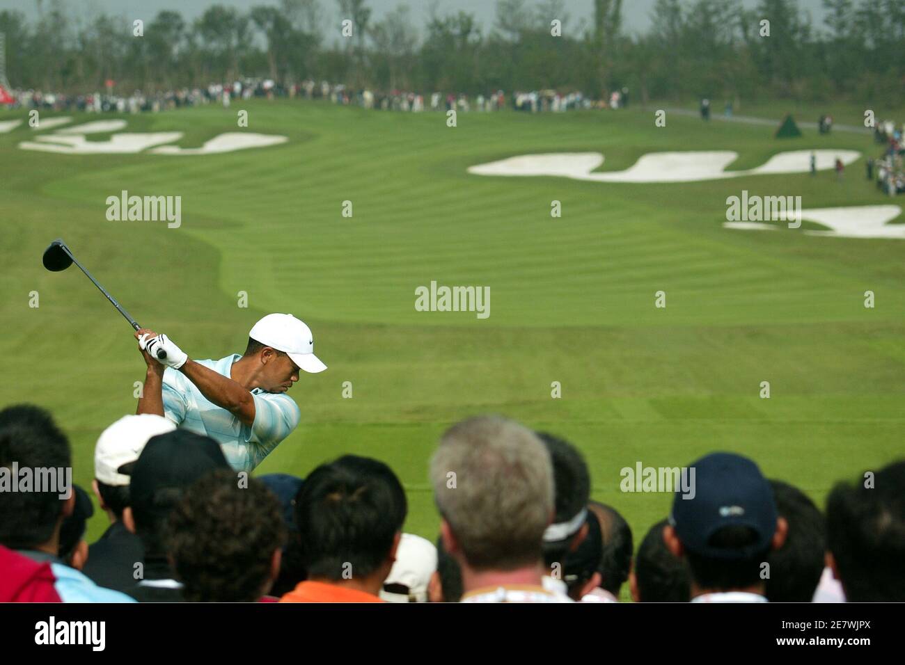 U.S. golfer Tiger Woods takes a shot towards the first hole during the 3rd day for the Champions Tournament in Shanghai, China November 12, 2005. Woods edged ominously to within a shot of leader David Howell at the Champions Tournament after a third-round 67 on Saturday. REUTERS/Aly Song Stock Photo