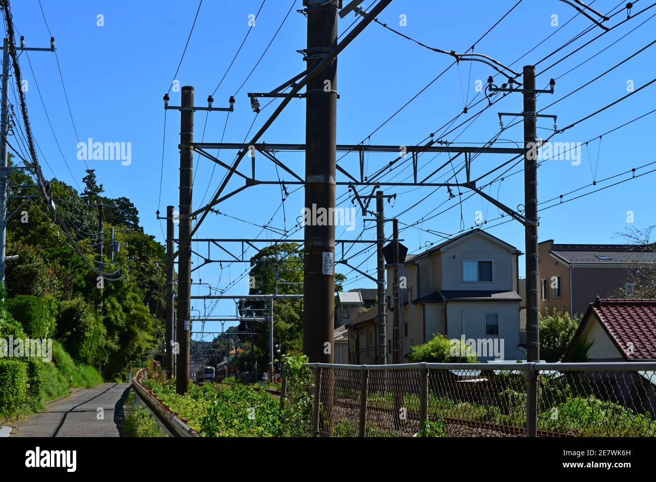 Suburban Japanese railway with green on the sidewalk Stock Photo - Alamy