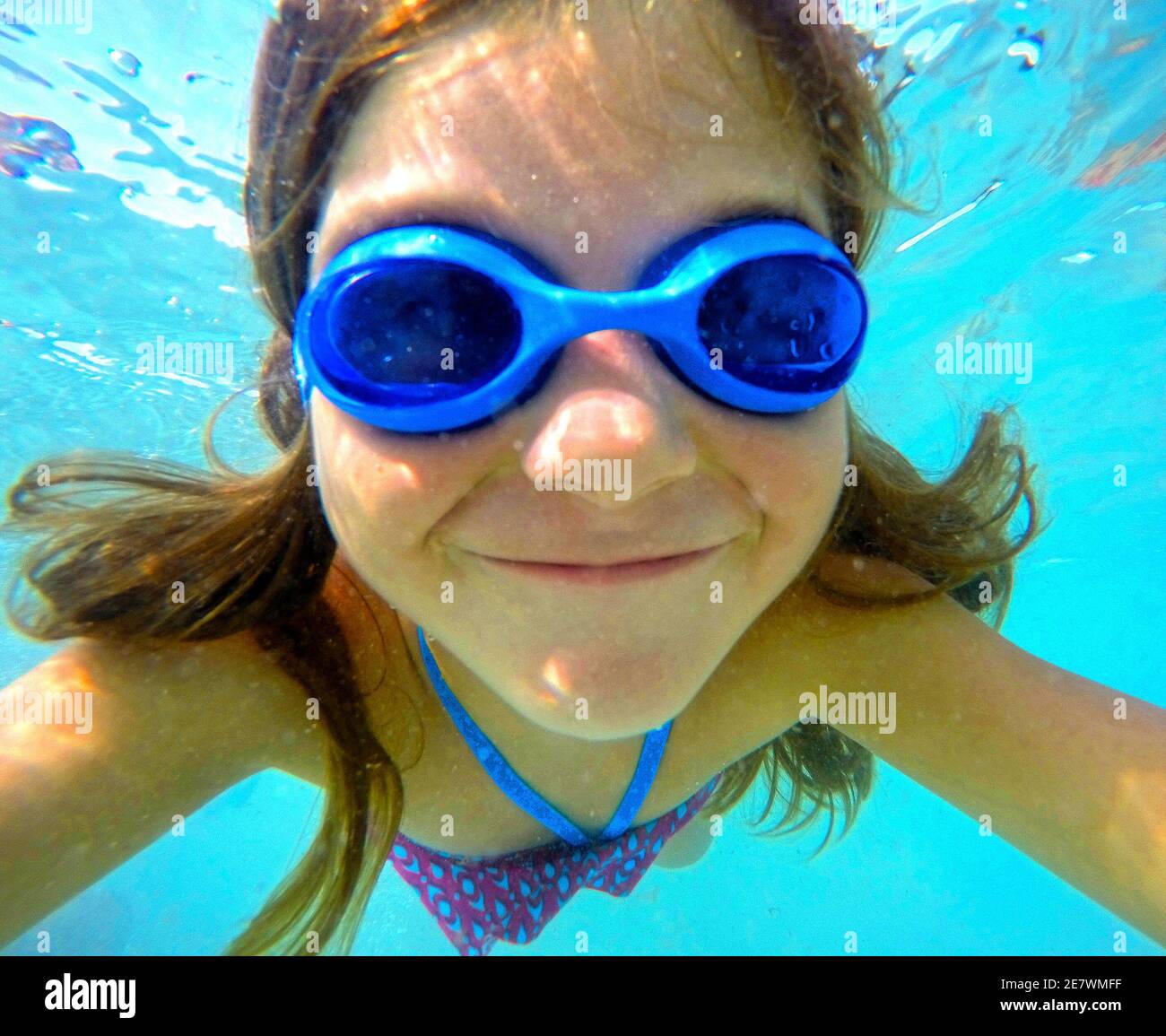 Child swimming underwater with goggles Stock Photo Alamy