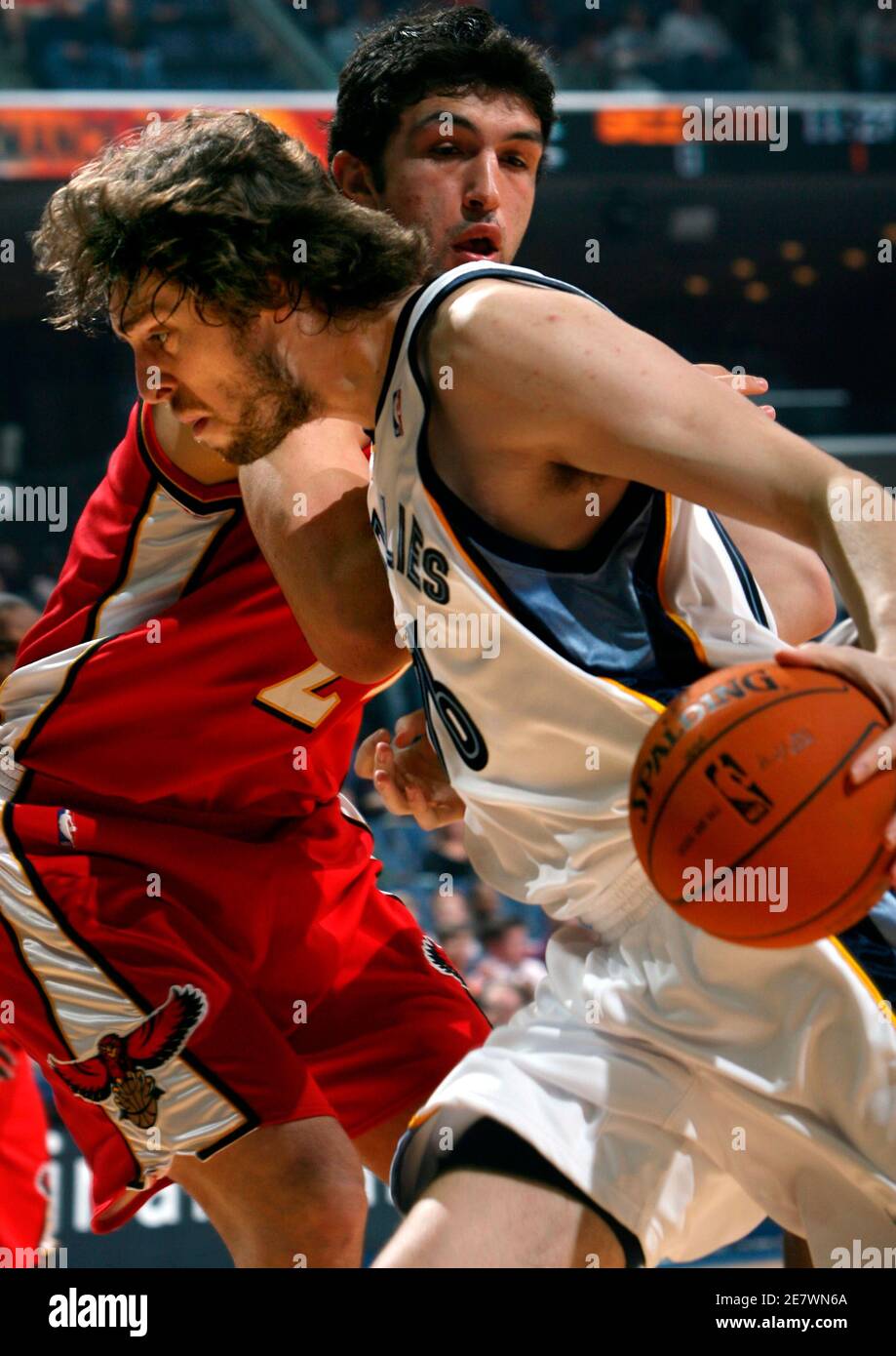 Memphis Grizzlies forward Pau Gasol of Spain (16) drives along the baseline  defended by Atlanta Hawks center Zaza Pachulia of Georgia during the first  quarter of NBA basketball action in Memphis, Tennessee,