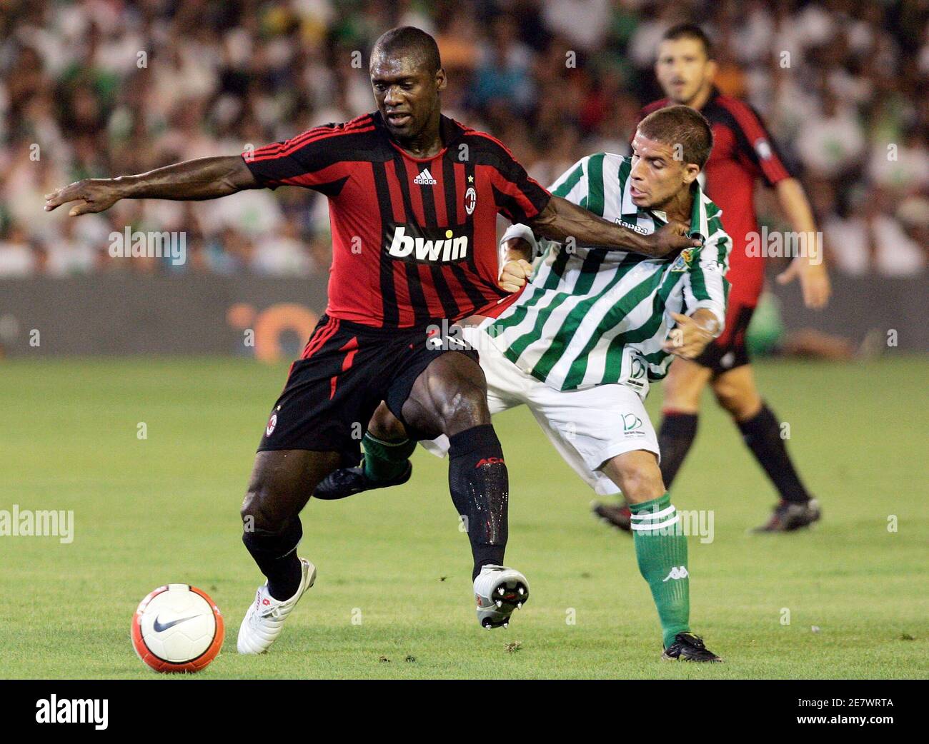 Real Betis' Alberto Rivera Pizarro (R) fights for the ball with AC Milan's  Clarence Seedorf during their friendly soccer match at Real Betis' Manuel  Ruiz de Lopera stadium in Seville August 9,