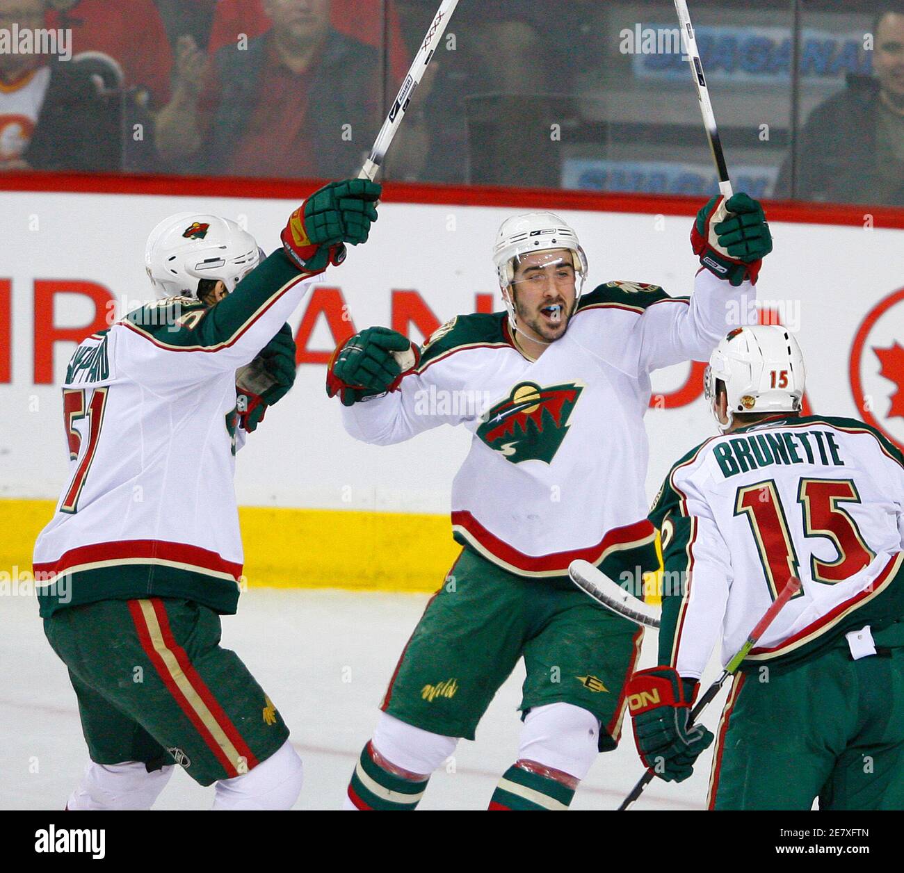 Minnesota Wild James Sheppard (L) and Cal Clutterbuck (C) celebrate teammate Andrew Brunette's goal during the first period of their NHL hockey game against the Calgary Flames in Calgary, Alberta March 28, 2009. REUTERS/Todd Korol (CANADA SPORT ICE HOCKEY) Stock Photo