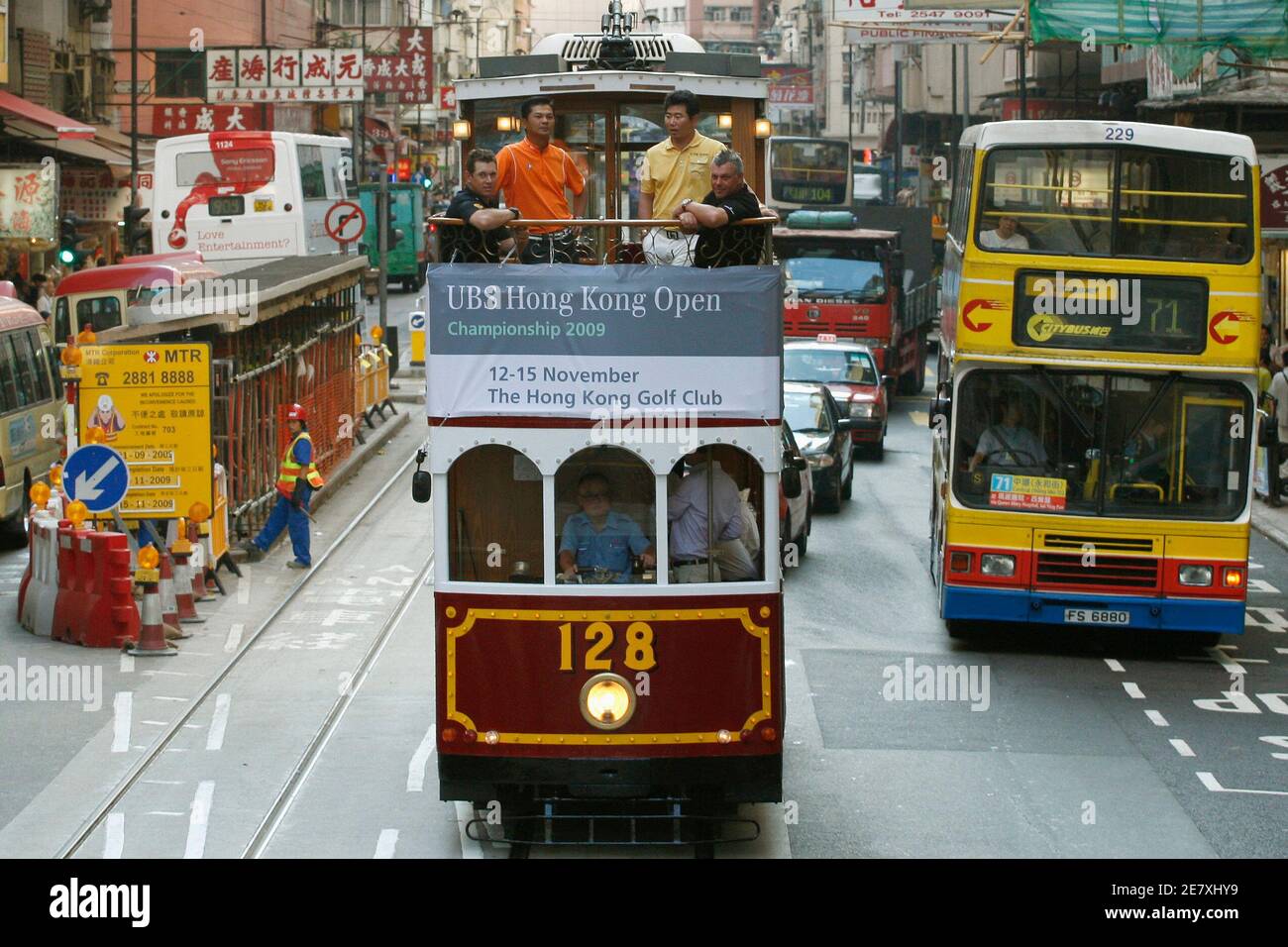 Lee Westwood of Britain (L), Lin Wen-tang of Taiwan (2nd L), Y.E. Yang of South Korea and Darren Clarke of Northern Ireland (R) tour the city by tram ahead of the Hong Kong Open golf tournament November 10, 2009.  REUTERS/Tyrone Siu  (CHINA SPORT GOLF TRAVEL) Stock Photo
