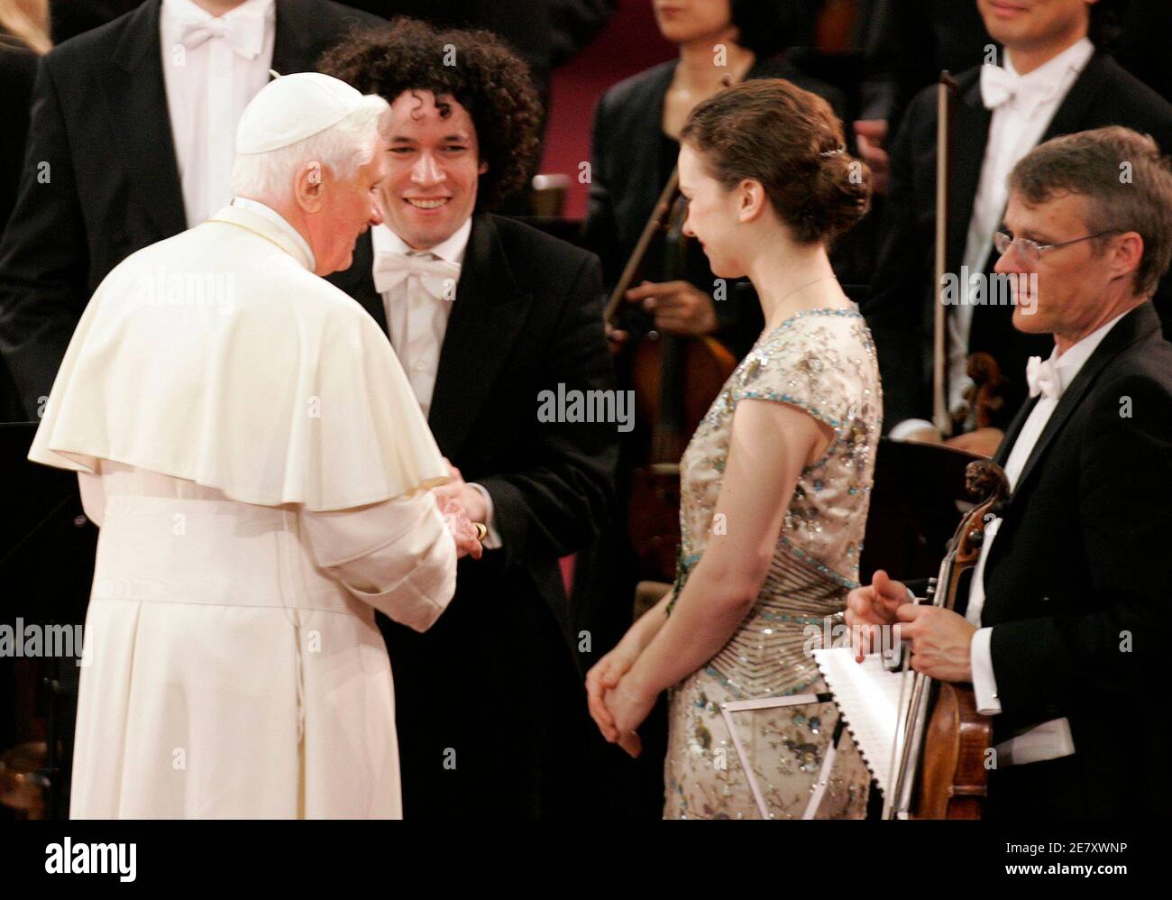 Pope Benedict XVI greets solo violinist Hilary Hahn (2nd R) and conductor  Gustavo Dudamel (2nd L) after they performed a special concert for Pope's  80th birthday at Paul VI hall at Vatican