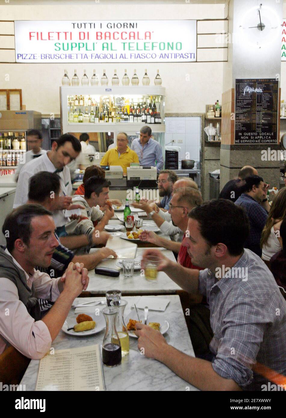 Diners crowd the Ai Marmi pizzeria restaurant in the Rome neighborhood of  Trastevere May 11, 2007. The minimal decor and lively atmosphere make  eating here a journey to a bygone time when
