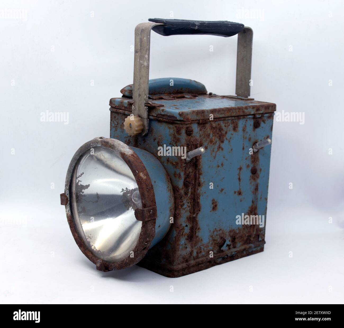 Old rusty blue railway lantern on white background. Stock Photo