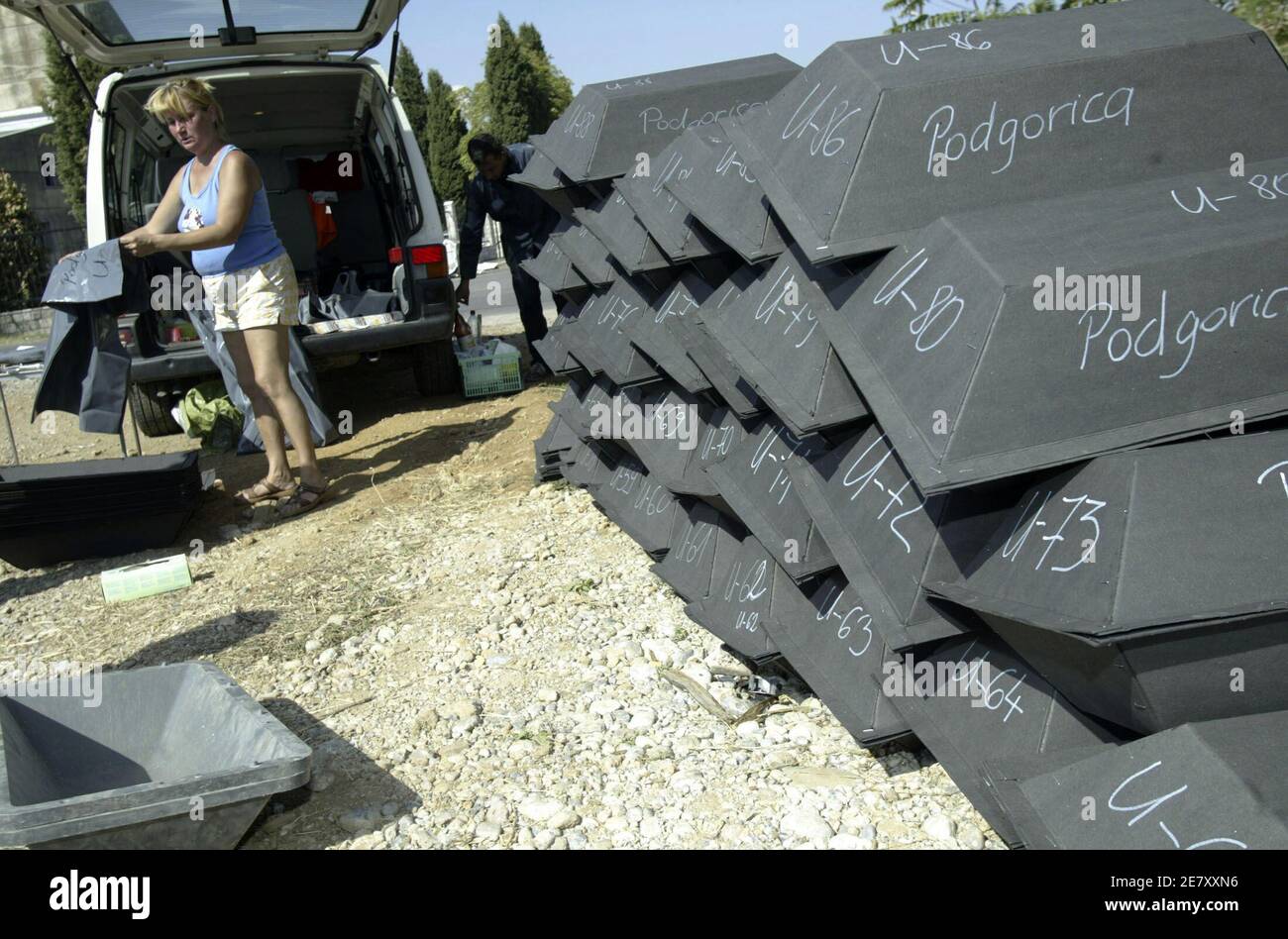 A woman staples shut cardboard coffins containing the remains of German WWII soldiers in Podgorica September 18, 2007. Montenegrin authorities in cooperation with a German agency this week began the excavation of a site believed to contain the remains of several hundred German soldiers who were buried there by their comrades in World War Two. Picture taken September 18, 2007.   REUTERS/Stevo Vasiljevic (MONTENEGRO) Stock Photo