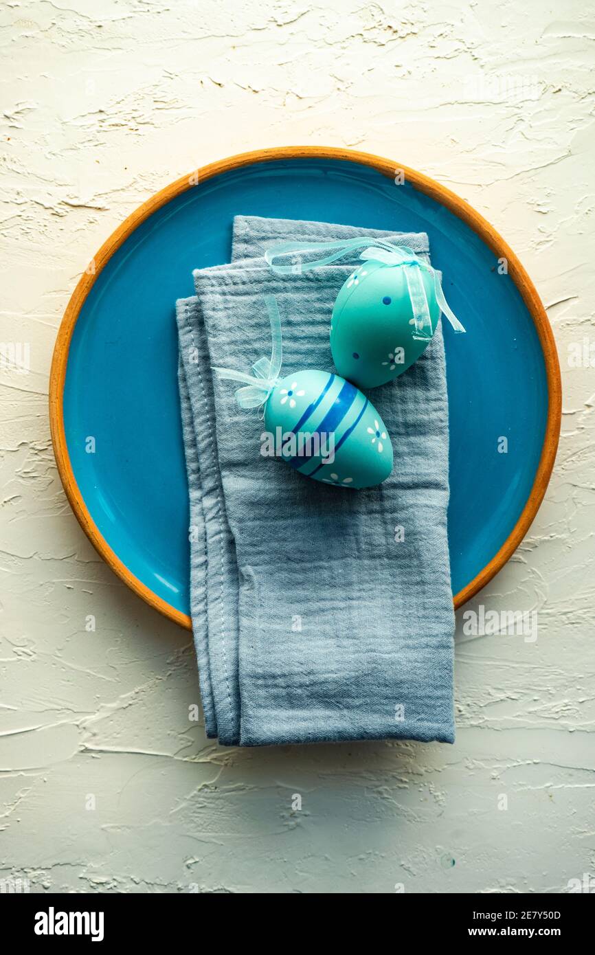 Easter table setting with colored eggs on stone background Stock Photo