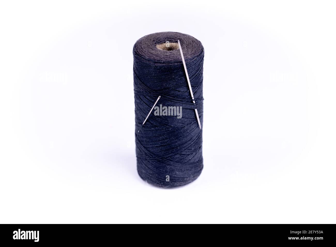 a needle with a thread on a white background Stock Photo