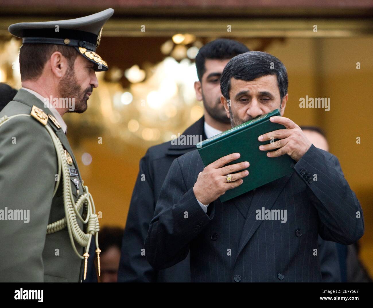 EDITORS' NOTE: Reuters and other foreign media are subject to Iranian restrictions on their ability to film or take pictures in Tehran.  Iran's President Mahmoud Ahmadinejad (R) kisses a copy of the Koran before leaving for Denmark at the International Mehrabad Airport in Tehran December 17, 2009. Ahmadinejad will address the U.N. climate summit in Copenhagen.   REUTERS/Raheb Homavandi (IRAN - Tags: POLITICS ENVIRONMENT RELIGION IMAGES OF THE DAY) Stock Photo