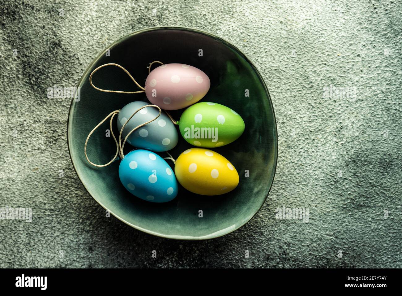Easter table setting with colored eggs on stone background Stock Photo