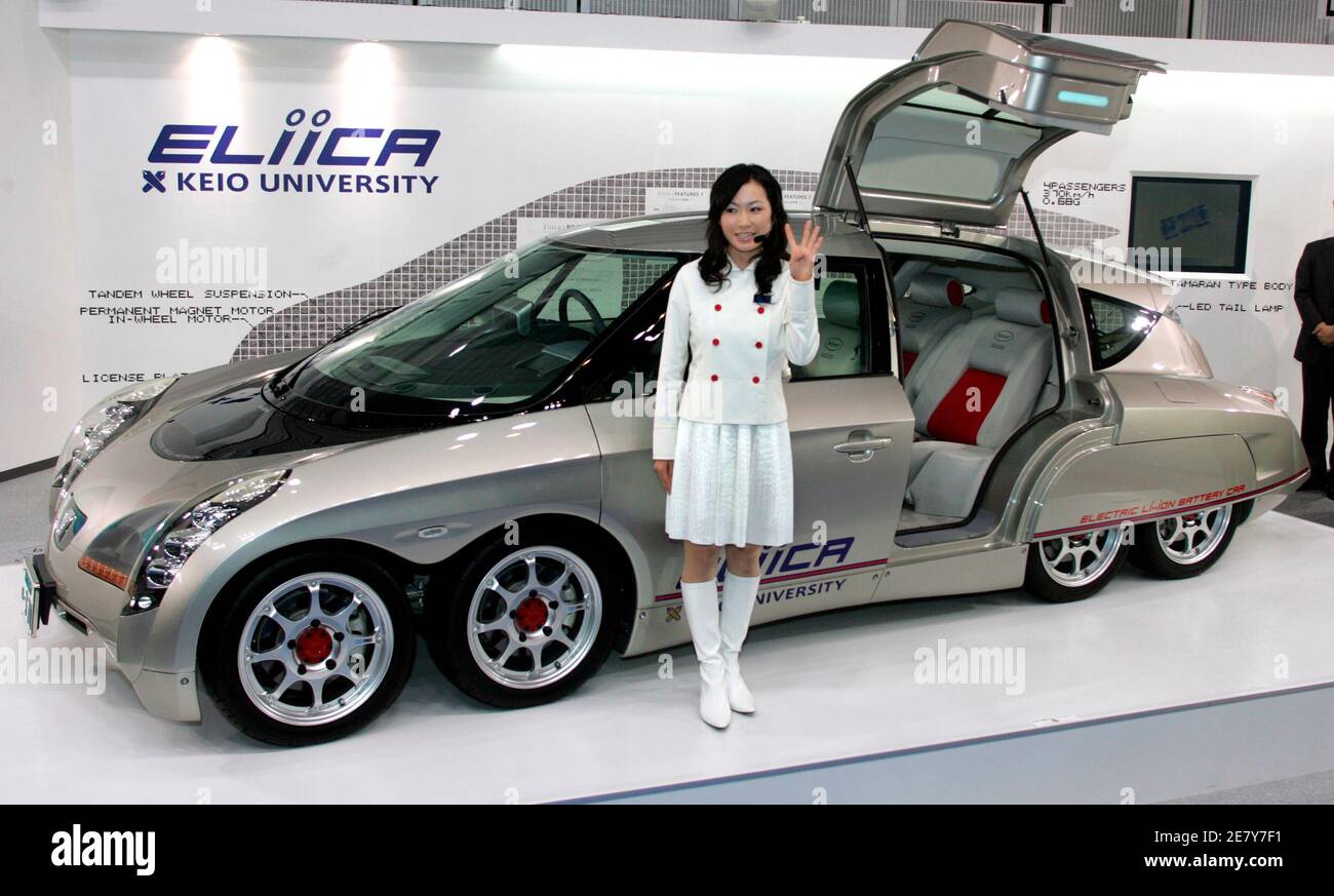 A Japanese woman poses in front of a prototype eight wheels drive electric  vehicle "Eliica", which Japan's Keio University has developed, at the Tokyo  Motor Show at Makuhari Messe in Chiba, east