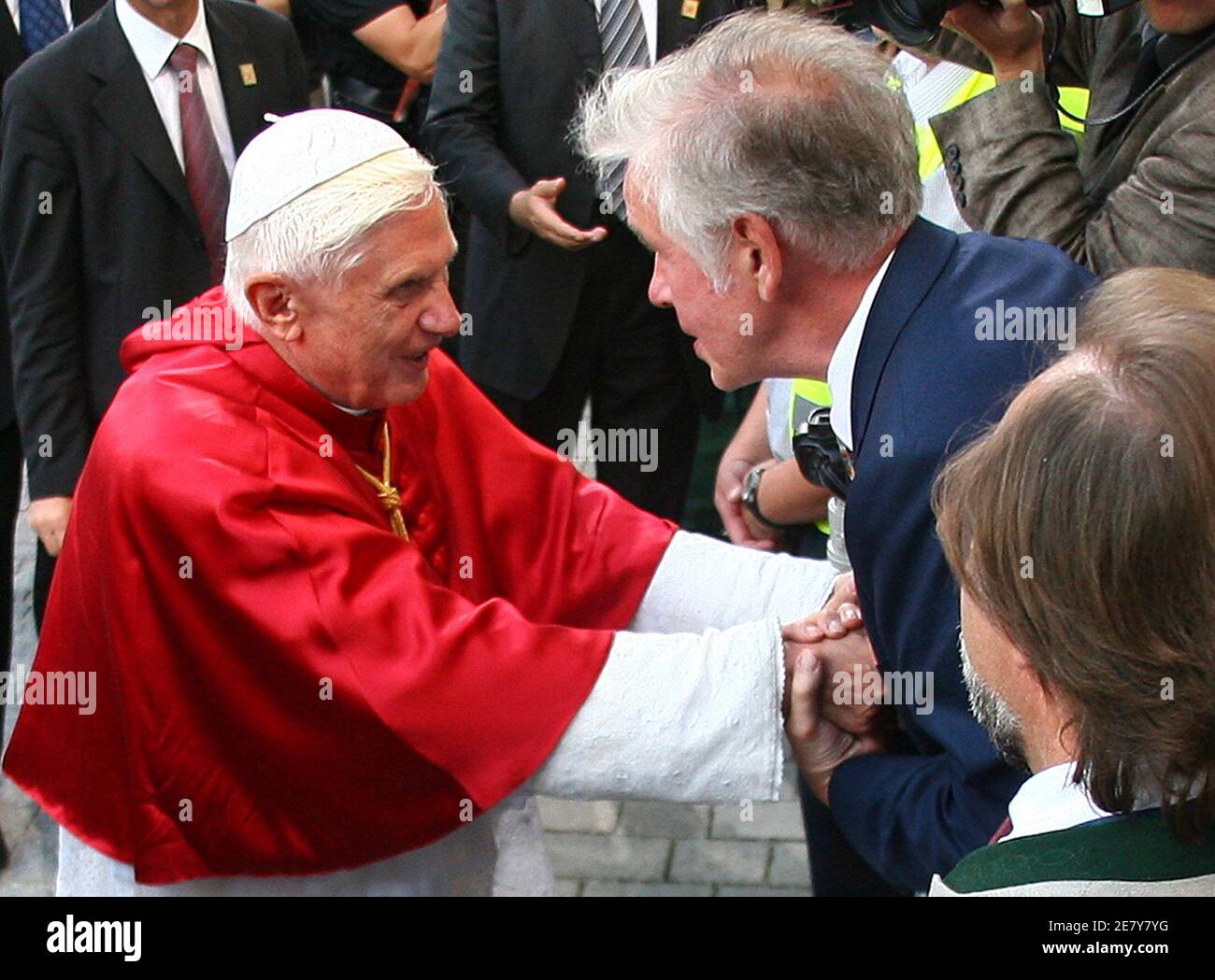 Pope Benedict XVI shakes hands with Ulrich Hommes (R) the philosopher  responsible for the sentences written on the so-called 'Benedict column'  which has been erected in front of the Pope's birthplace during