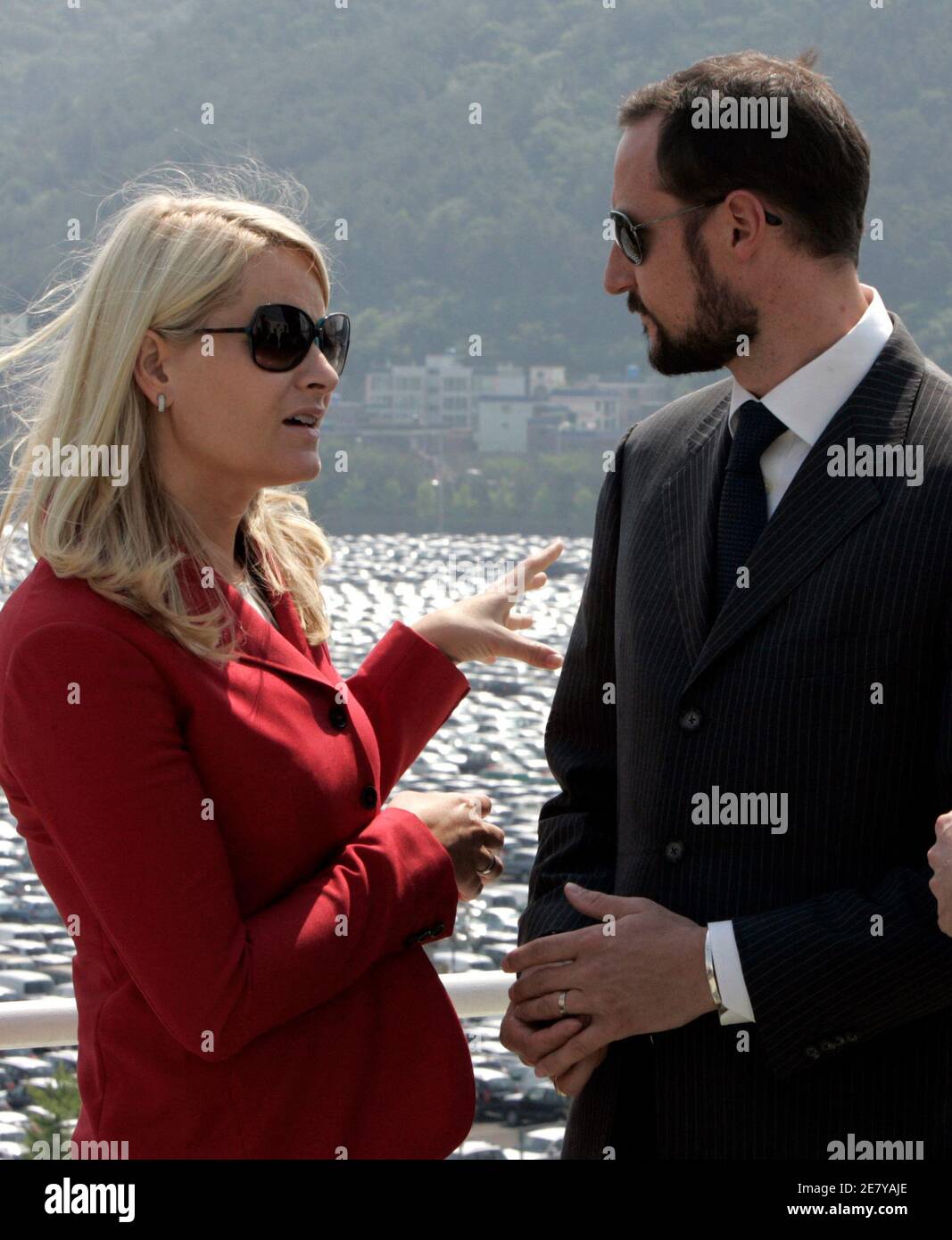 Norwegian Crown Prince Haakon (R) and Crown Princess Mette-Marit talk during their visit for one of the ships owned by Wilh. Wilhelmsen's Korean joint venture EUKOR, which handles all car exports from South Korea for Hyundai Motor Company and Kia Motors corporation, at Hyundai Motor's export port in Ulsan, about 410 km (256 miles) southeast of Seoul, May 11, 2007.  REUTERS/Jo Yong-Hak (SOUTH KOREA) Stock Photo