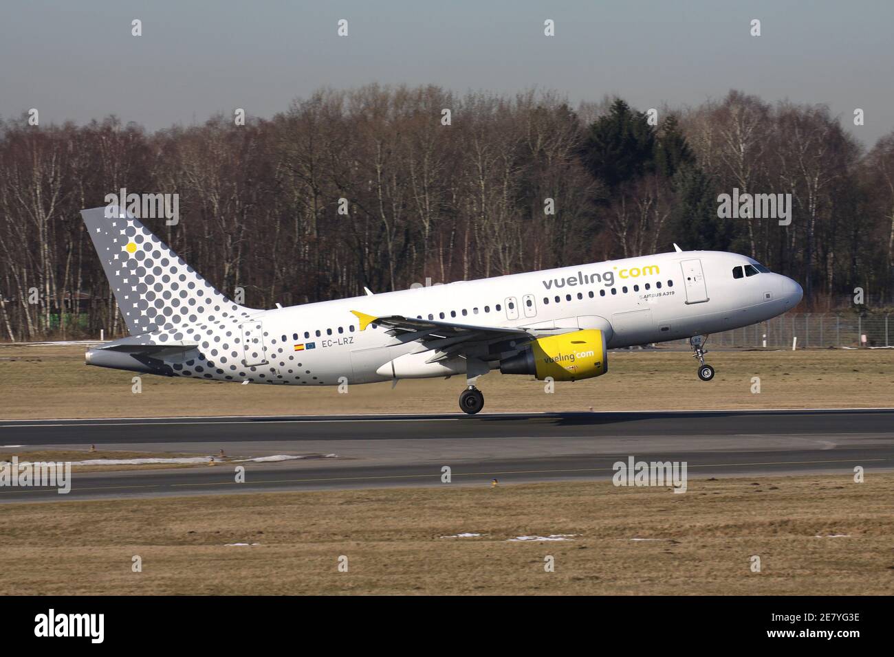 Spanish Vueling Airbus A319-100 with registration D-AKNU on take off roll on runway 33 of Hamburg Airport. Stock Photo
