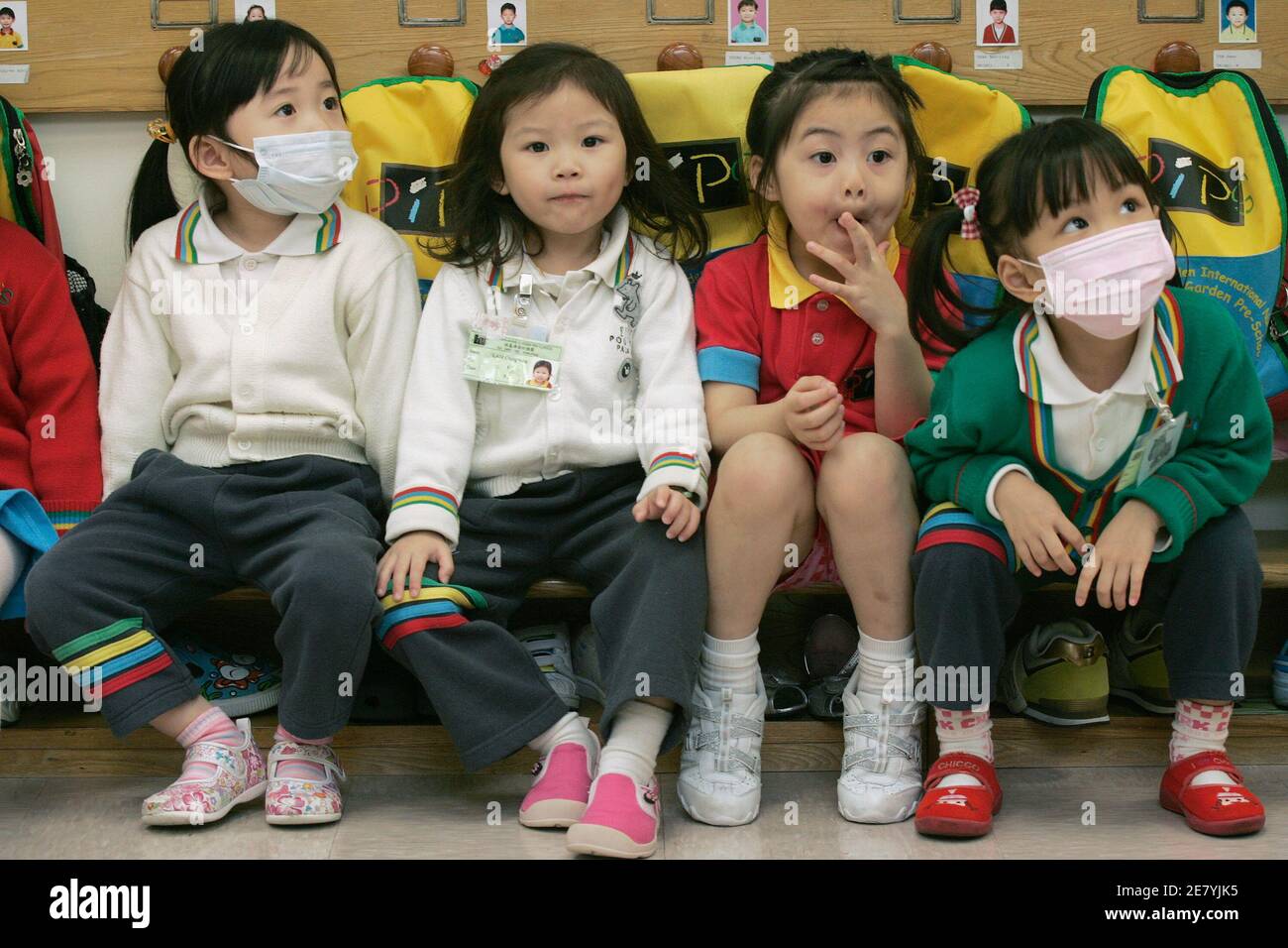 Kindergarten students wear masks while attending a lesson in Hong Kong April 30, 2009. The World Health Organization said on Wednesday the world is at the brink of a pandemic, raising its threat level as the swine flu virus spread and killed the first person outside of Mexico, a toddler in Texas.     REUTERS/Tyrone Siu    (CHINA EDUCATION HEALTH) Stock Photo