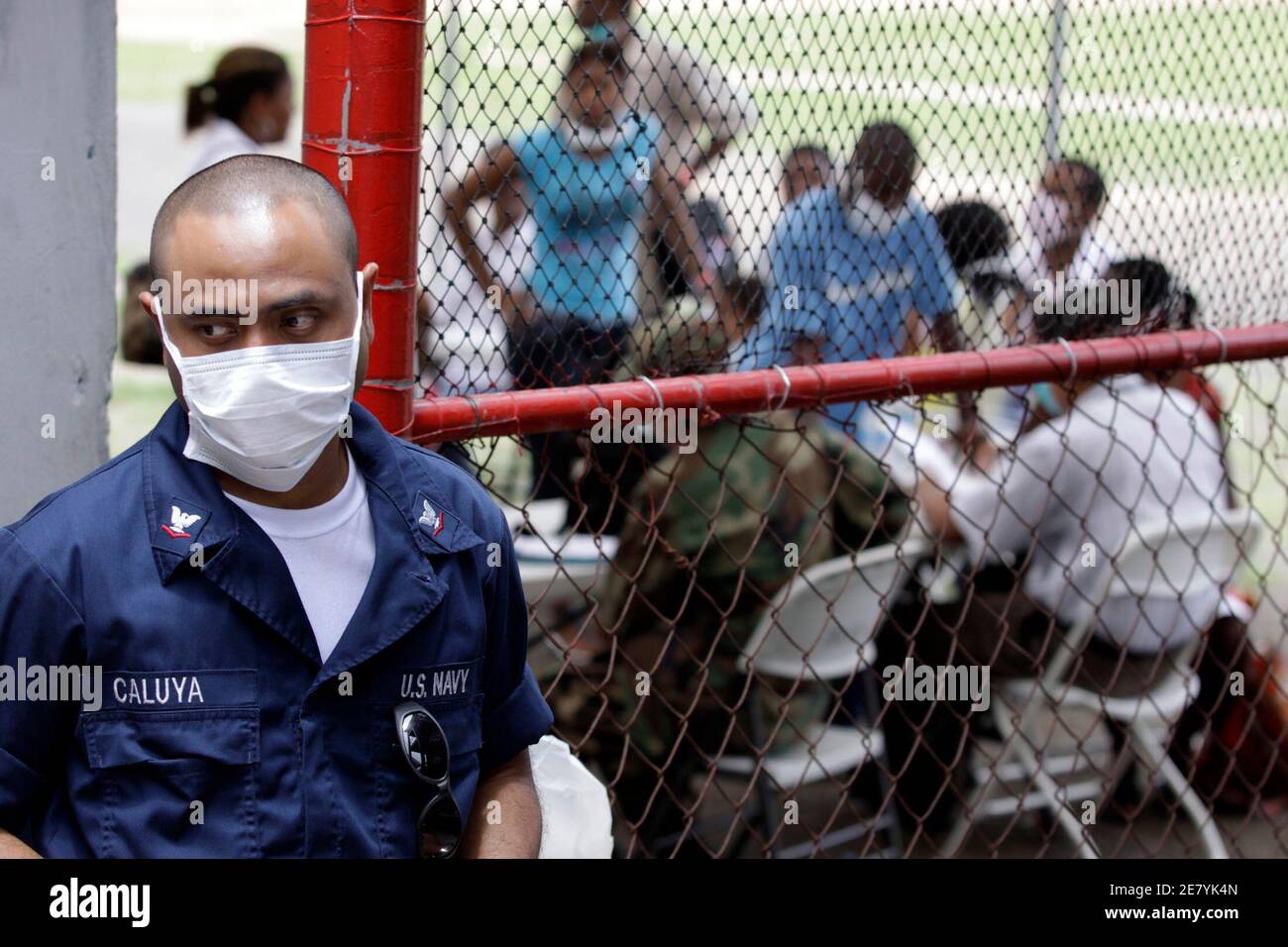 A U.S. Navy officer from the USNS Comfort hospital ship stands outside a stadium gate where patients with symptoms of the influenza A H1N1 virus are being treated in Colon City, May 28, 2009. Panama's health department announced that the total number of people infected had risen to 107. REUTERS/Alberto Lowe (PANAMA SOCIETY HEALTH MILITARY) Stock Photo
