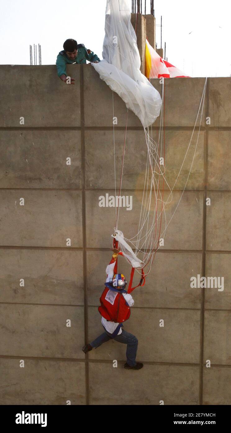 A policeman tries to rescue Russian base jumper Valery Rozov after his  parachute got stuck in a nearby building during a 29 storey-high (116 m) base  jump, in attempt to express his