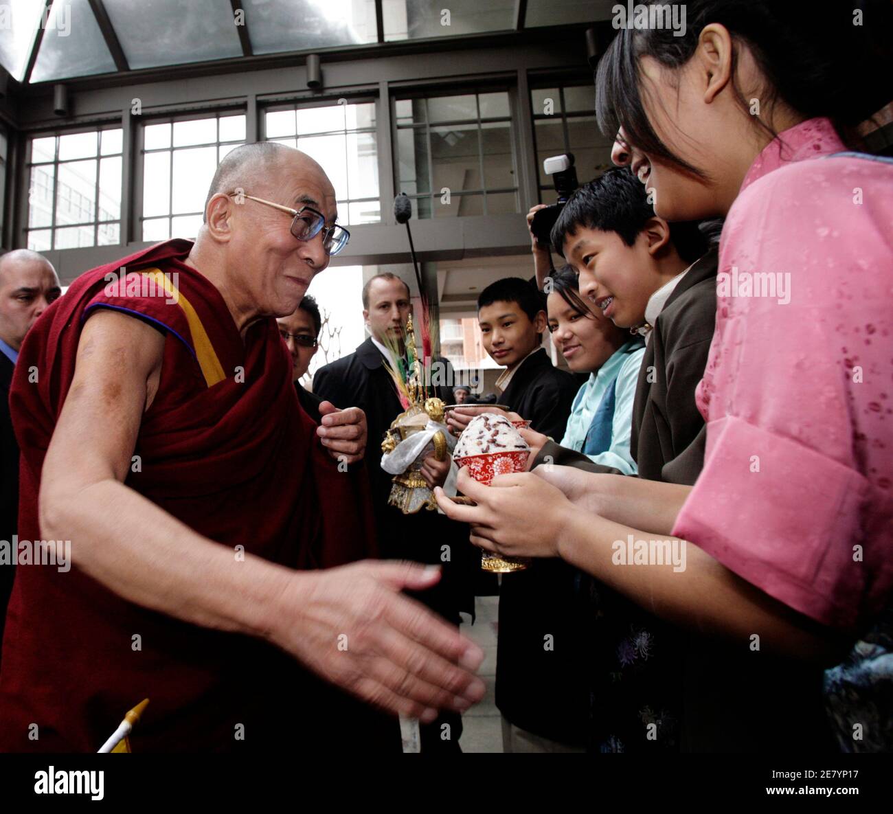 The Tibetan spiritual leader the Dalai Lama is greeted by members of the Tibetan community as he arrives at a hotel in Washington February 17, 2010. U.S. President Barack Obama plans to meet the Dalai Lama on February 18, a move that has been denounced by China. The Obama administration delayed meeting the Dalai Lama, who has lived in exile since a failed Tibetan uprising in 1959, until after Obama's November visit to Beijing so as not to inflame tensions with China, which accuses the monk of separatism. REUTERS/Yuri Gripas (UNITED STATES - Tags: POLITICS RELIGION) Stock Photo