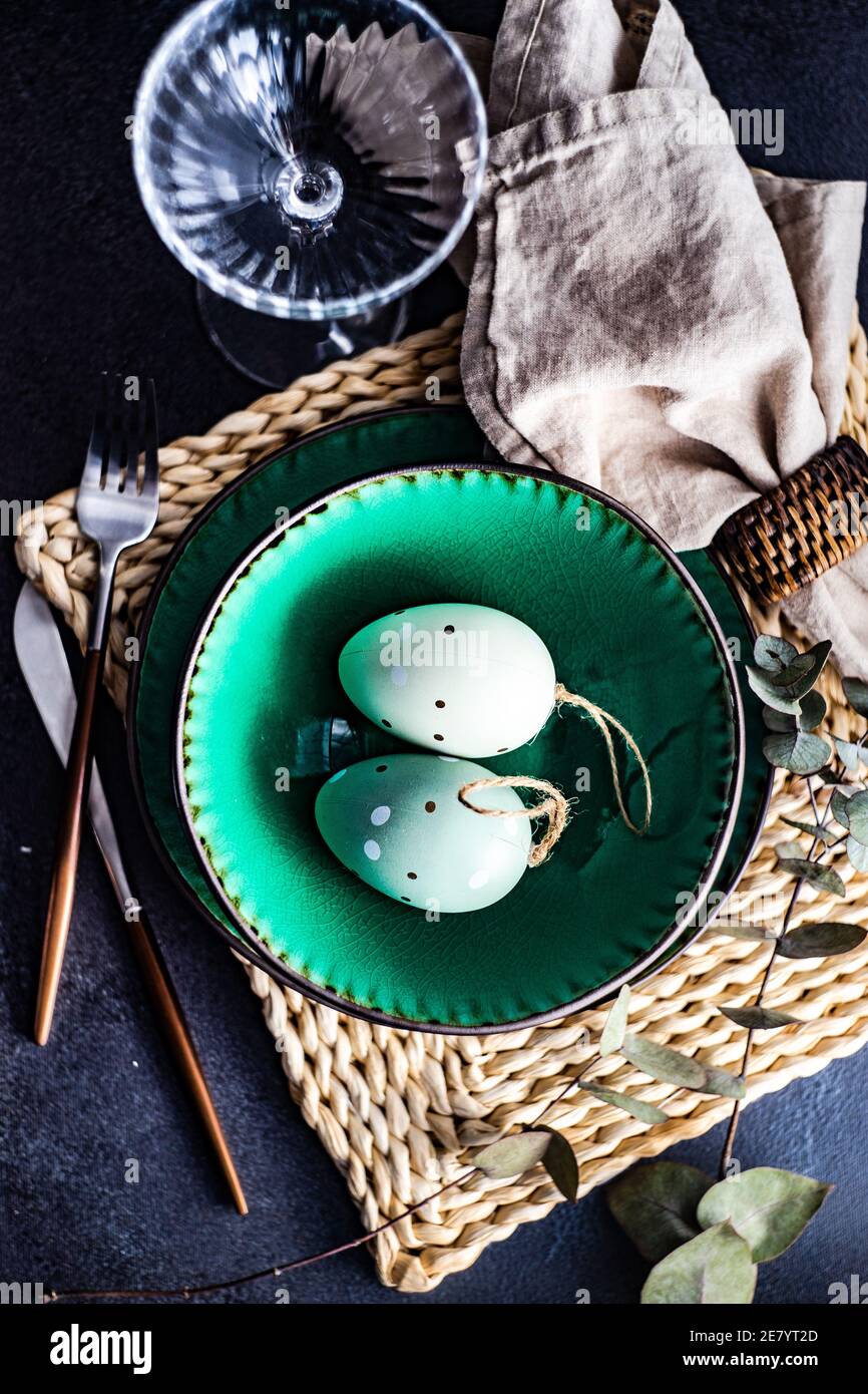 Festive place setting for Easter dinner with eggs on table Stock Photo