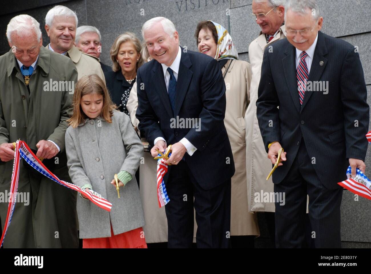 U.S. Defense Secretary Robert Gates (C) and Hannah Woolsey (2nd L), from the United States participate in a ribbon cutting ceremony for a new visitor's center at the Normandy American Cemetery in France, on the 63rd anniversary of D-Day in Colleville-sur-Mer June 6, 2007. REUTERS/Kristin Roberts (FRANCE) Stock Photo