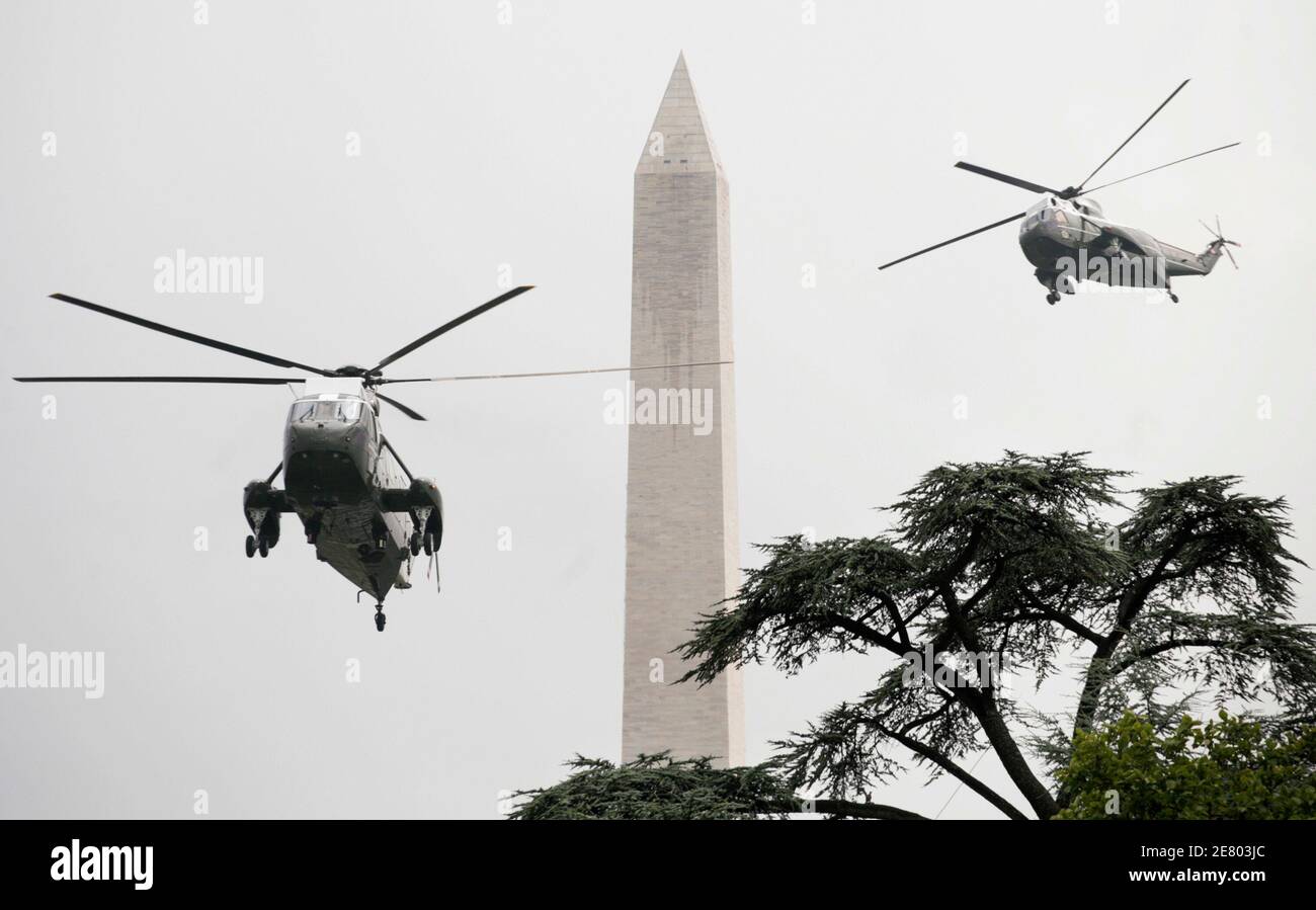 The Marine One helicopter with U.S. President George W. Bush on board (L) arrives at the White House as a backup helicopter flies by the Washington Monument July 30, 2007. Bush returned to the White House after a meeting with new British Prime Minister Gordon Brown in Camp David earlier today. REUTERS/Yuri Gripas (UNITED STATES) Stock Photo