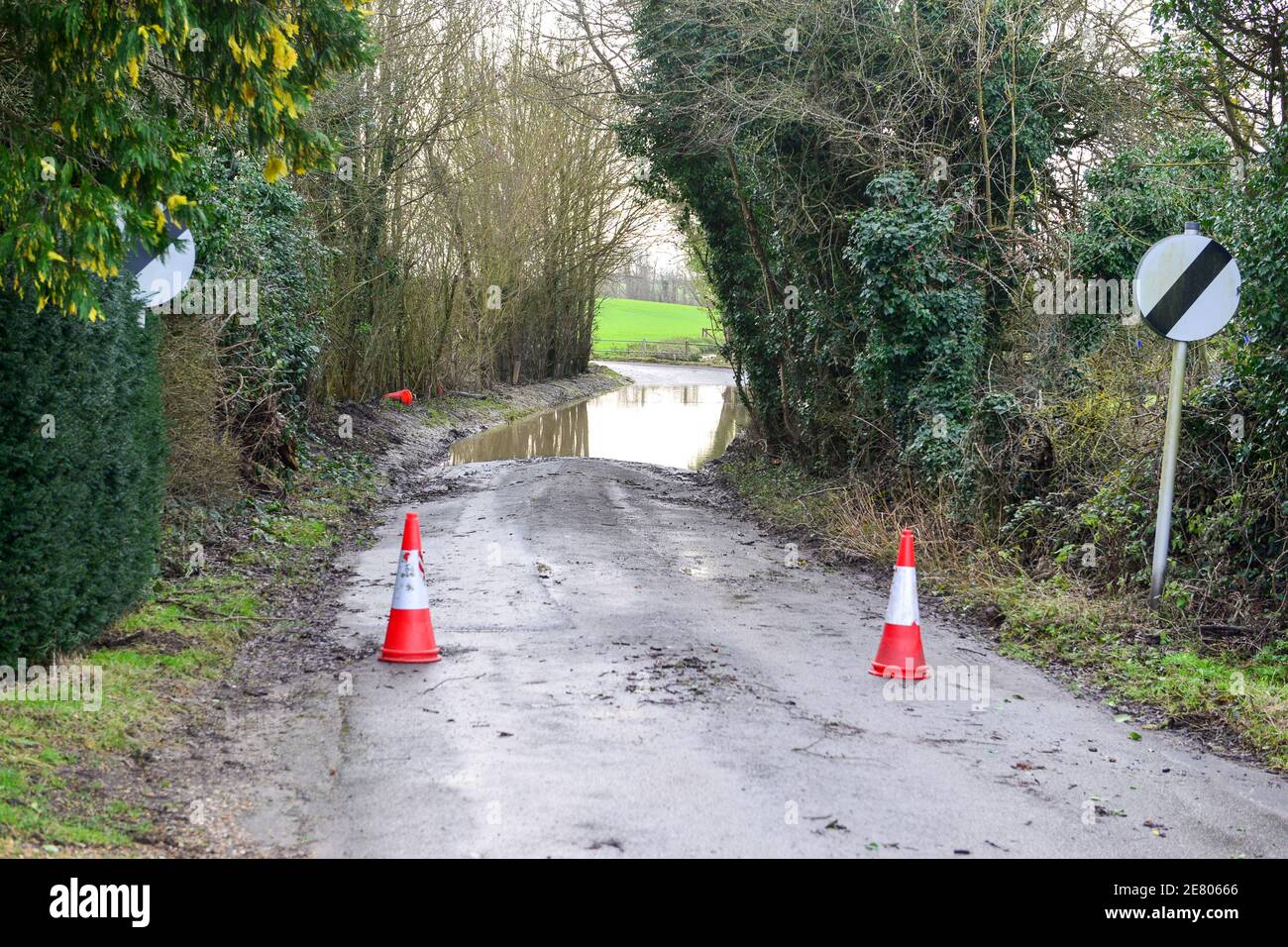 Bollard with flooded country road Stock Photo - Alamy
