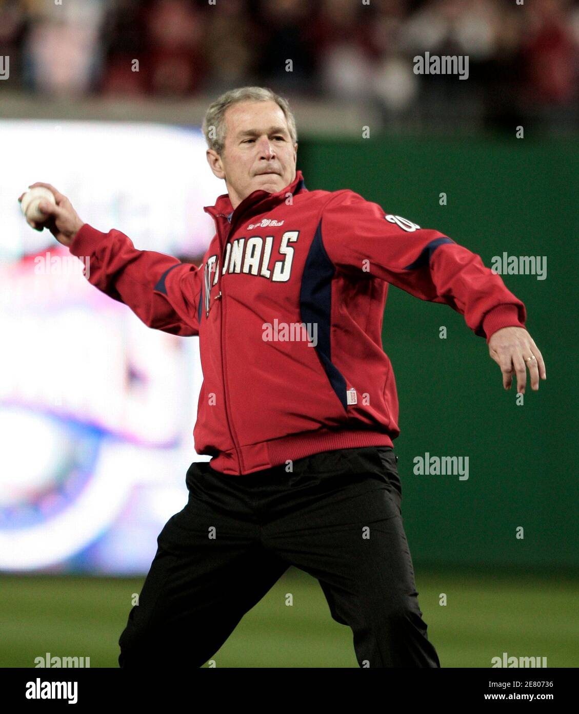President George W. Bush throws out the first ball at the new Nationals Park before the MLB baseball game between the Washington Nationals and Atlanta Braves in Washington March 30, 2008.     REUTERS/Gary Cameron   (UNITED STATES) Stock Photo