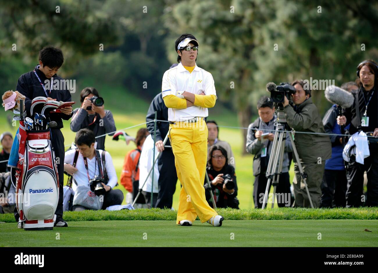 Golfer Ryo Ishikawa, 17, of Japan and his caddie Hiroyuki Kato (L) wait their turn on the ninth hole during a practice round in preparation for the Northern Trust Open golf tournament in the Pacific Palisades area of Los Angeles February 17, 2009. REUTERS/Gus Ruelas (UNITED STATES) Stock Photo