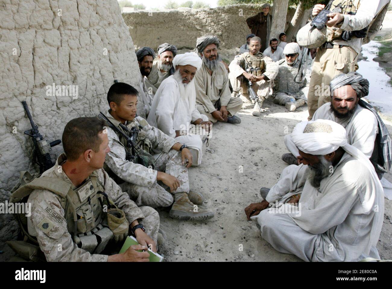 U.S. Marines from Foxtrot Company, 2nd Batallion, 8th Marines, meet local elders during a shura, or local council meeting, in Sorkhdoz in Afghanistan's lower Helmand River Valley July 5, 2009. Thousands of Marines advanced into the valley by helicopter and ground this week in the biggest military offensive of Barack Obama's presidency.    REUTERS/Peter Graff  (AFGHANISTAN MILITARY POLITICS) Stock Photo