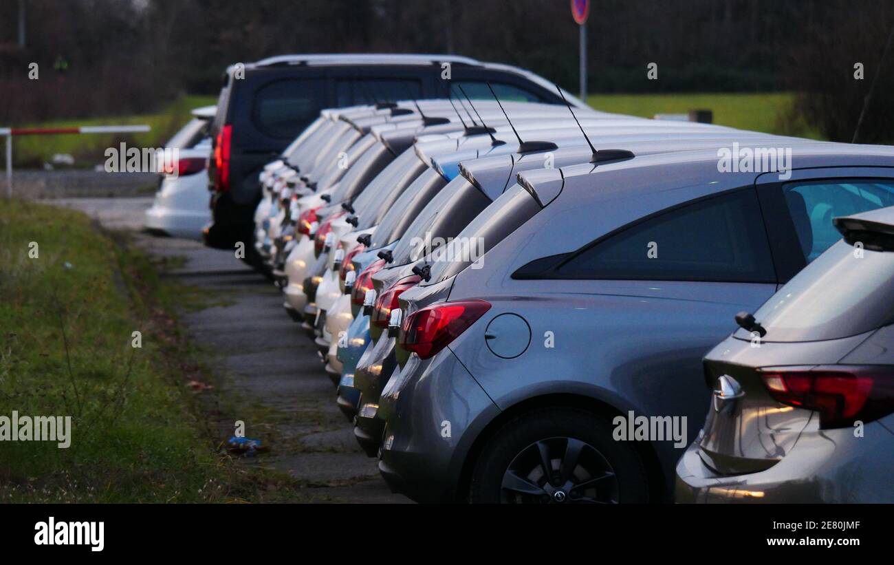 New unregistered cars stand in a line after production Stock Photo