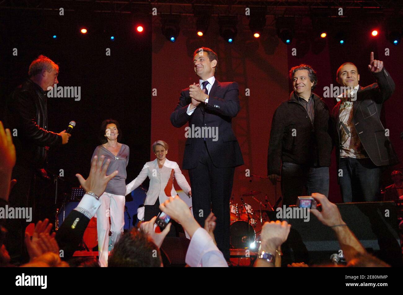 France's newly-elected president Nicolas Sarkozy addresses his supporters alongside actor Christian Clavier and singer Faudel, Place de la Concorde in Paris, France, May 6, 2007. French voters elected reform-minded Nicolas Sarkozy as their new president on Sunday, giving him a comfortable winning margin, preliminary official results and projections from four polling agencies showed. With more than half of the vote counted, Sarkozy was scoring just over 53 percent to a little more than 46 percent for Socialist Segolene Royal. Polling agencies also had the conservative Sarkozy winning 53 percent Stock Photo