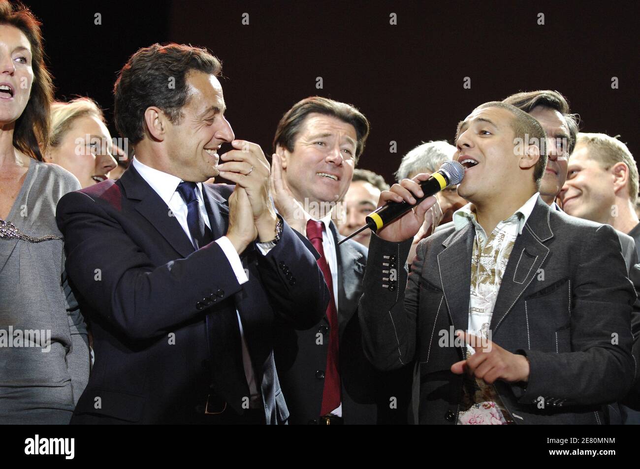 France's newly-elected president Nicolas Sarkozy addresses his supporters alongside his wife Cecilia and singer Faudel, Place de la Concorde in Paris, France, May 6, 2007. French voters elected reform-minded Nicolas Sarkozy as their new president on Sunday, giving him a comfortable winning margin, preliminary official results and projections from four polling agencies showed. With more than half of the vote counted, Sarkozy was scoring just over 53 percent to a little more than 46 percent for Socialist Segolene Royal. Polling agencies also had the conservative Sarkozy winning 53 percent of the Stock Photo