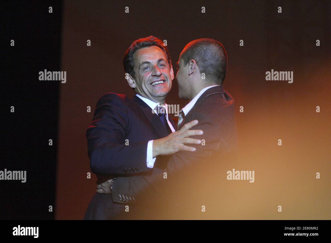 France's newly-elected president Nicolas Sarkozy is congratuled by singer Faudel as he addresses his supporters, Place de la Concorde in Paris, France, May 6, 2007. French voters elected reform-minded Nicolas Sarkozy as their new president on Sunday, giving him a comfortable winning margin, preliminary official results and projections from four polling agencies showed. With more than half of the vote counted, Sarkozy was scoring just over 53 percent to a little more than 46 percent for Socialist Segolene Royal. Polling agencies also had the conservative Sarkozy winning 53 percent of the vote c Stock Photo