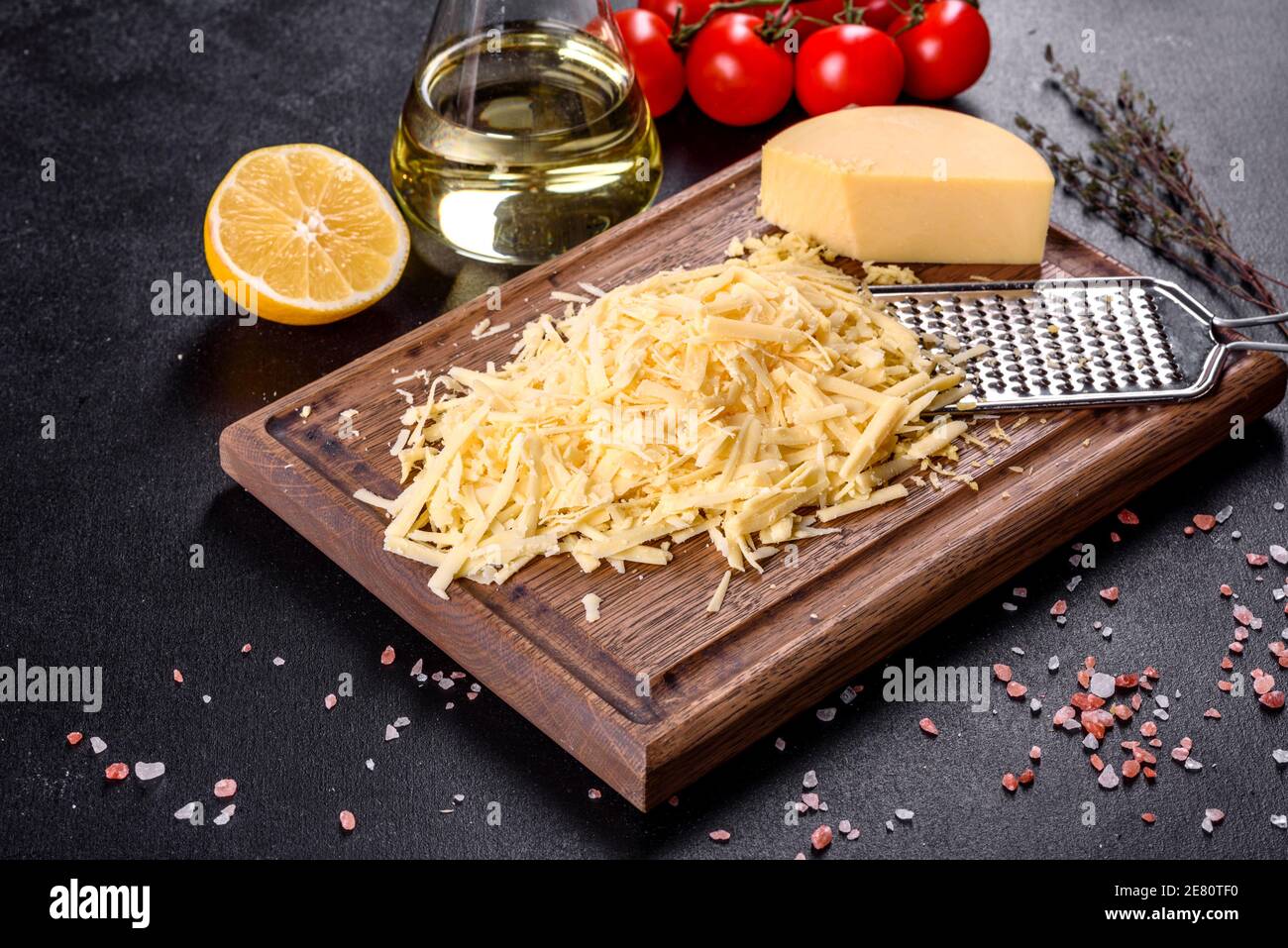 Italian hard cheese with grater on wooden background Stock Photo - Alamy