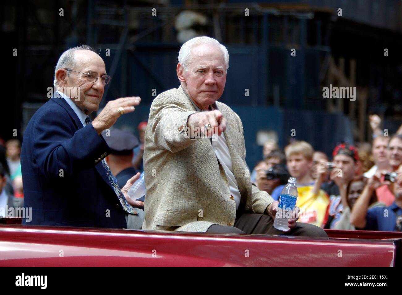 Former New York Yankees players Yogi Berra (L) and Whitey Ford ride in