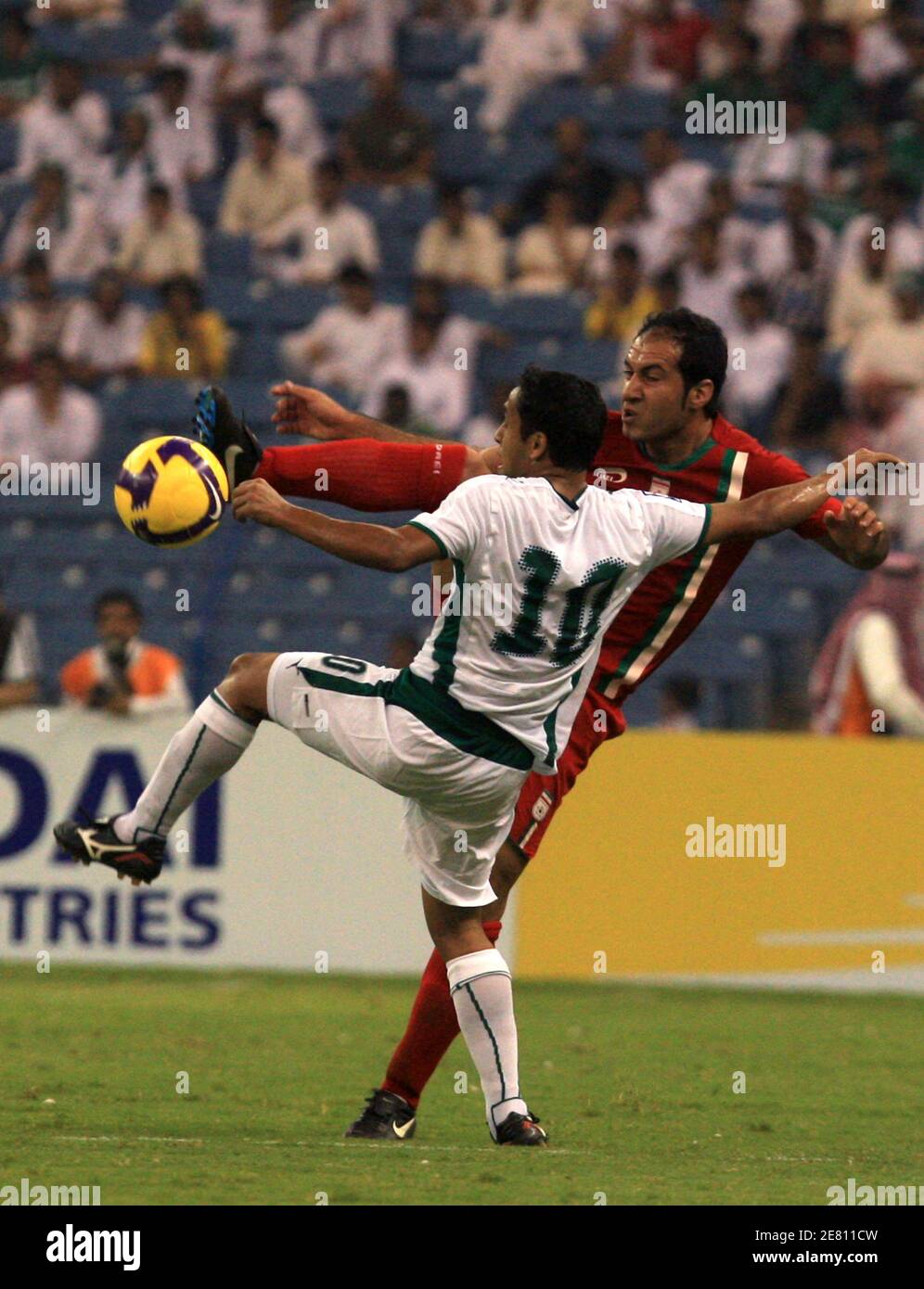 Saudi's Muhammad Shalhoub (L) fights for the ball with Iran's Star Zare during their World Cup 2010 qualifying soccer match in Riyadh September 6, 2008.  REUTERS/Fahad Shadeed  (SAUDI ARABIA) Stock Photo