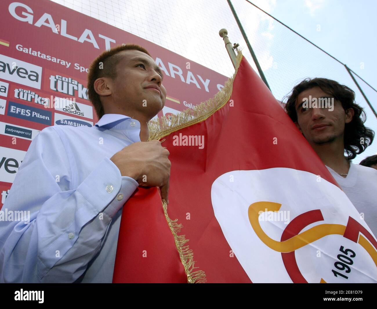 Junichi Inamoto Of Japan Poses With A Flag Of Turkish Soccer Club Galatasaray As Another New Recruit Mehmet Polat R Who Also Signed With The Club Stands Next To Him In Istanbul Junichi Inamoto Of Japan Poses With A Flag Of Turkish Soccer Club Galatasaray As Another New Recruit Mehmet Polat R Who Also Signed With The Club Stands Next To Him In Istanbul