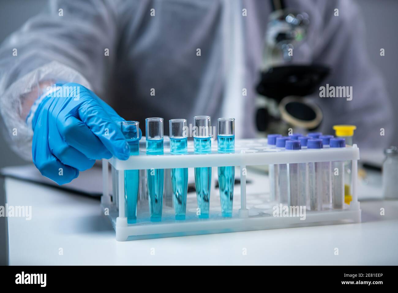 Biochemistry laboratory research, chemist in protective suit analyzing ...