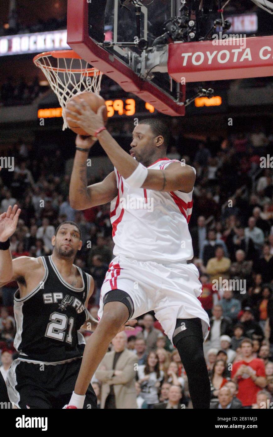 Houston Rockets' Tracy McGrady (1) knocks the ball away past San Antonio  Spurs Tim Duncan (21)