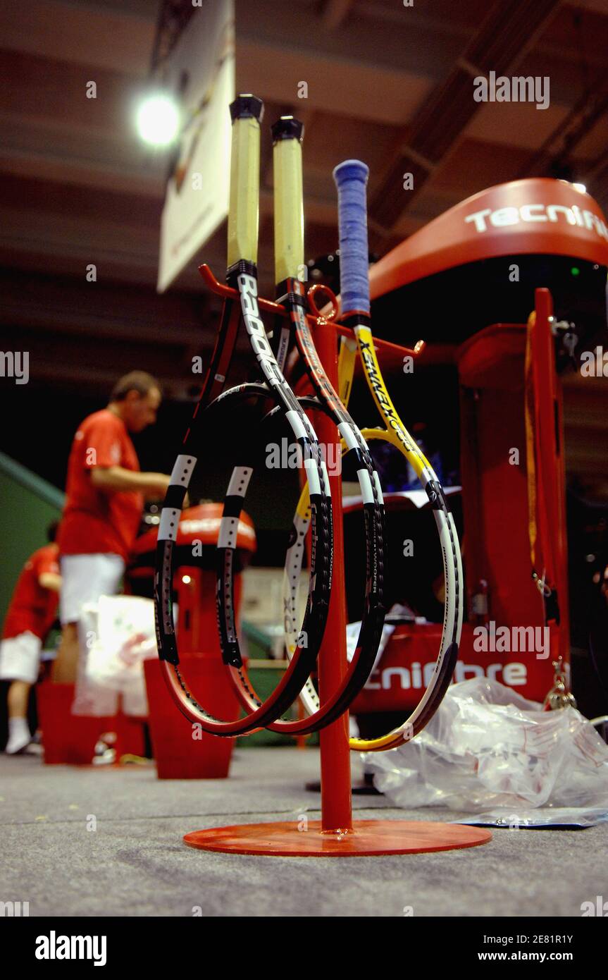 Specialized workers prepare stringing of tennis player's rackets before ...