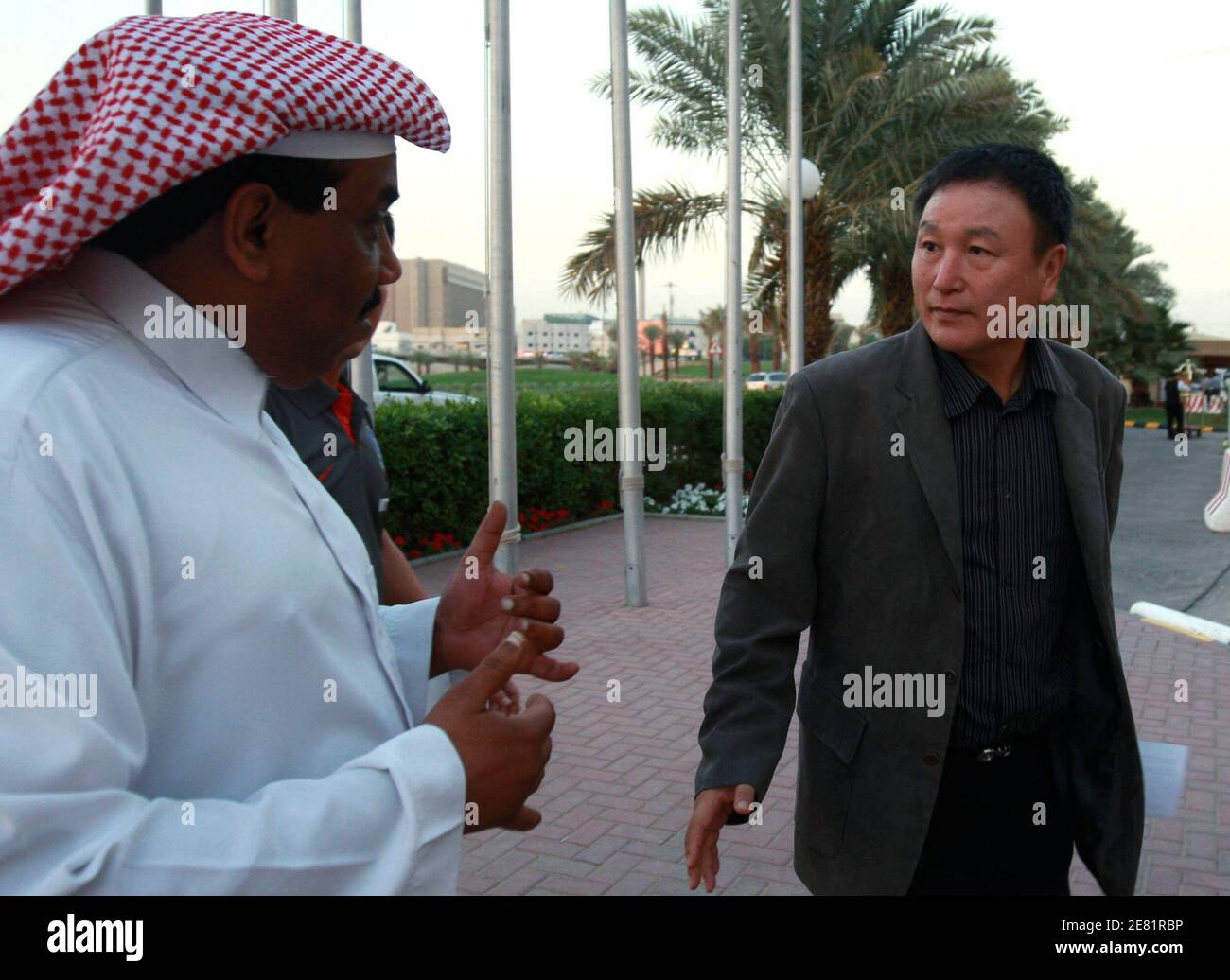South Korea's national soccer team coach Huh Jung-moo (R) is greeted by a hotel attendant as he arrives in Riyadh November 17, 2008. South Korea will play their World Cup 2010 qualifying soccer match against Saudi Arabia on November 19.    REUTERS/Fahad Shadeed   (SAUDI ARABIA) Stock Photo