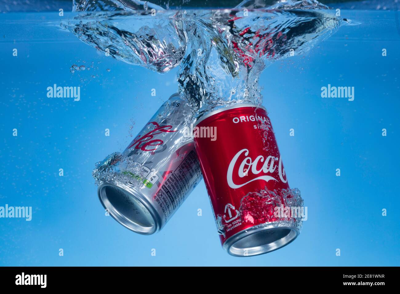 Freeze motion photo of mini cans of diet coke and coca cola dropped